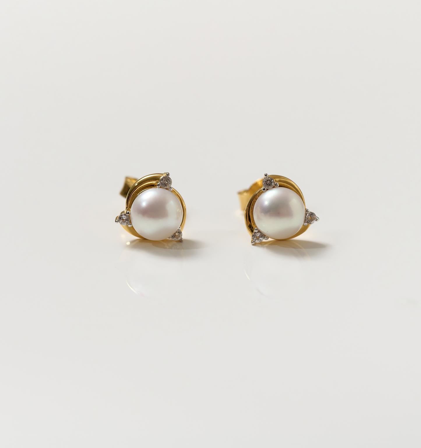 Nayana Earrings featuring pearls and topaz set in gold studs for elegant calm and clarity