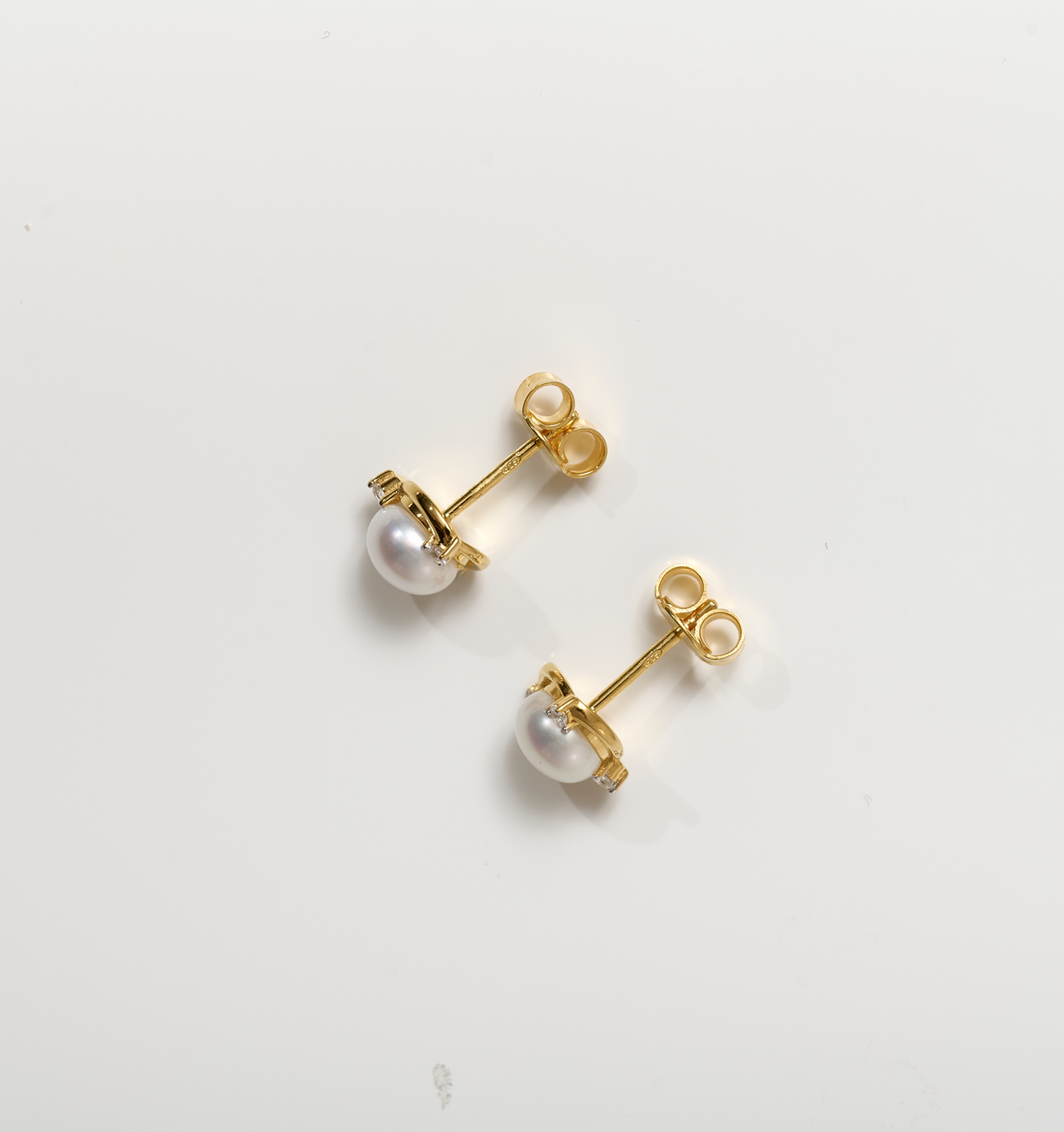 Nayana Earrings gold studs with pearls and topaz gemstones on white background