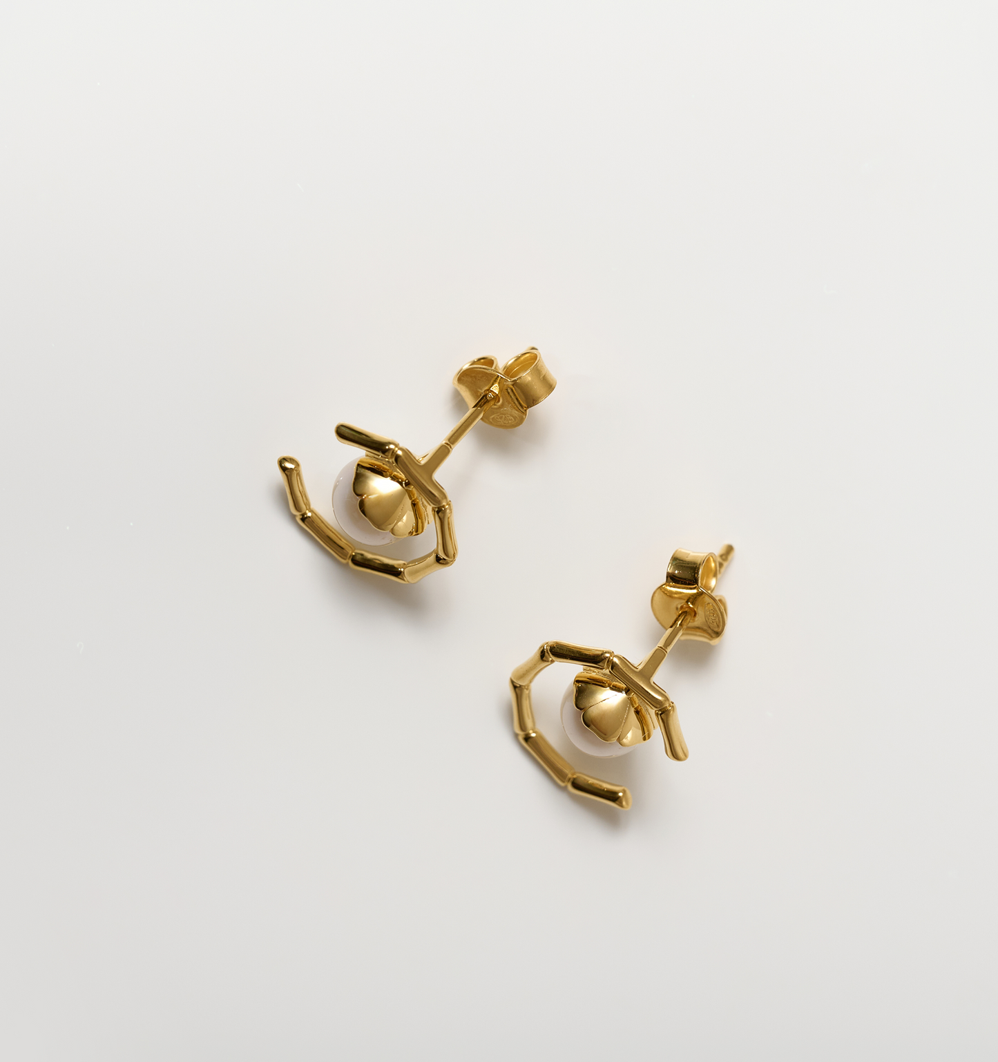 Kavach Earrings gold bamboo-inspired design with single pearl studs
