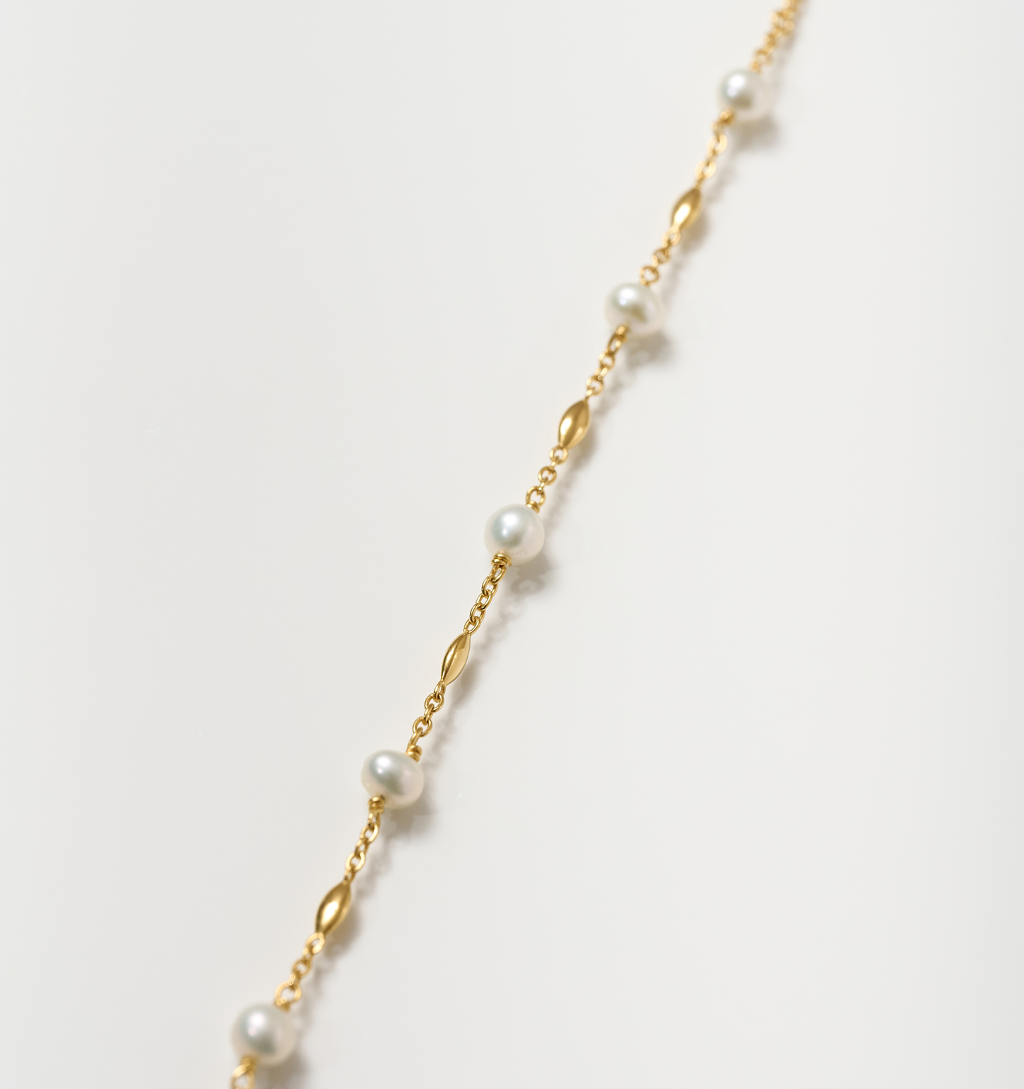 Manjari Necklace featuring five pearls spaced with gold beads on a delicate chain