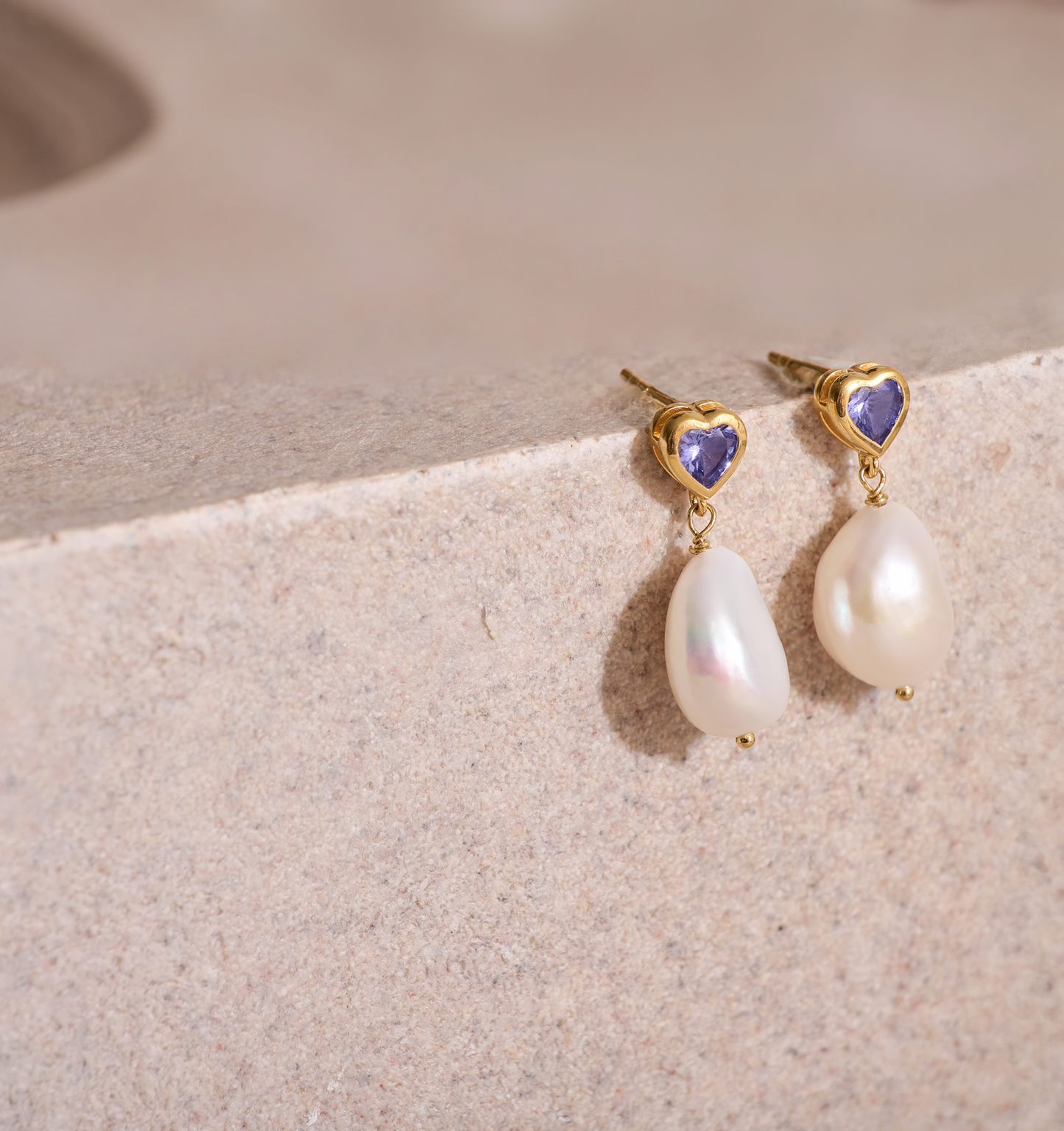 Hridaya Earrings with heart-shaped tanzanite and dangling pearls in gold setting