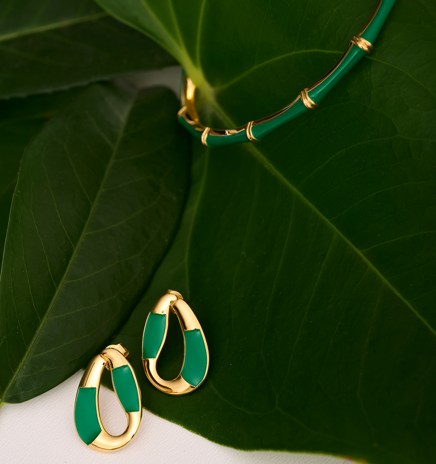 Vana Loop gold earrings and necklace with forest green enamel on large green leaves