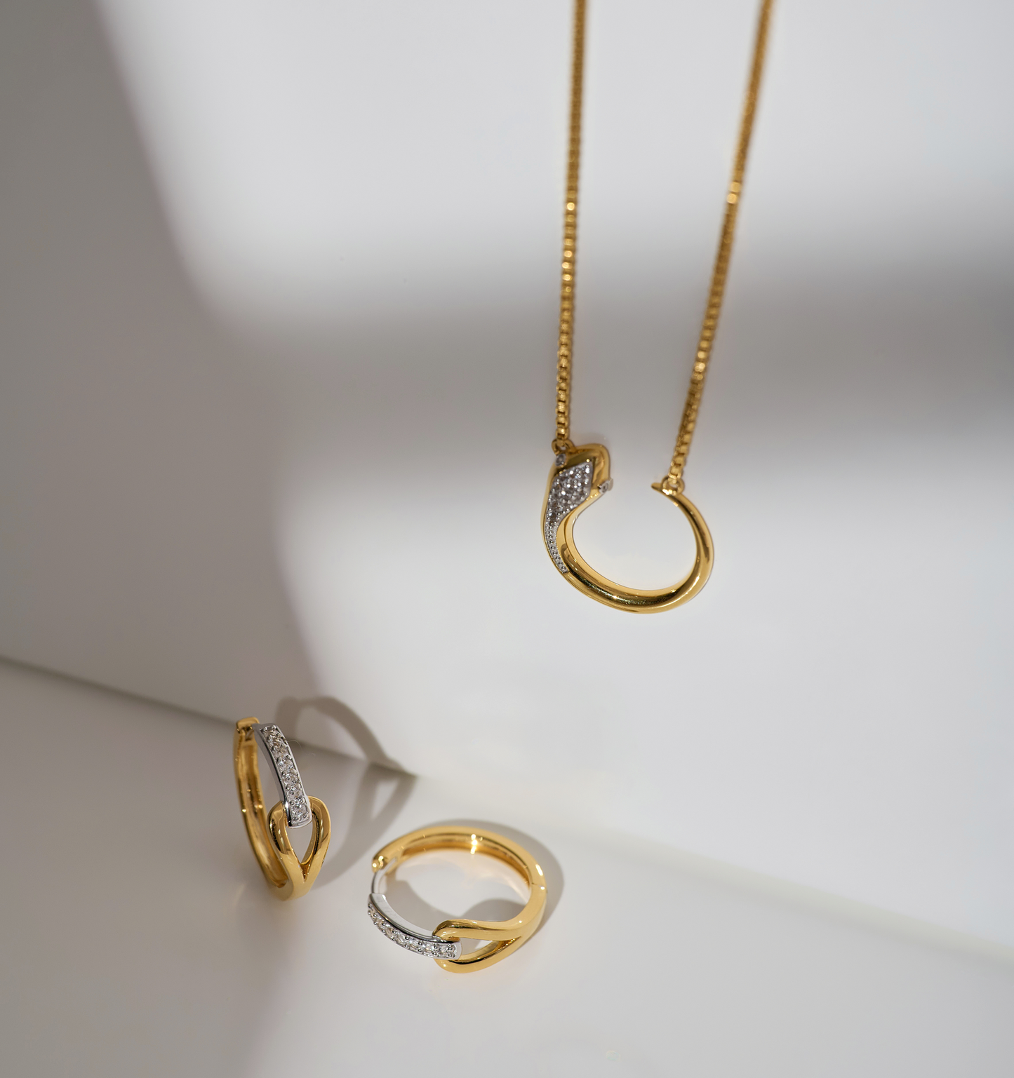 Ekatra Earrings gold and silver intertwined hoop design with delicate chain pendant set