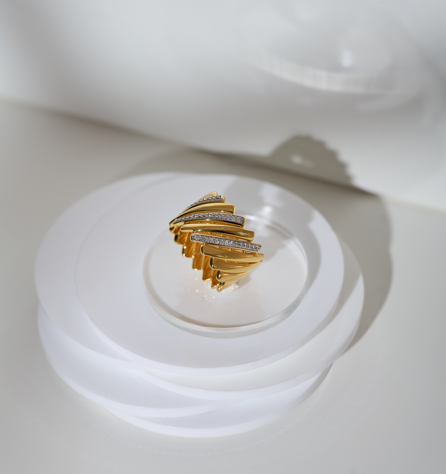 Reya Ring gold chevron design with 42 white topaz stones on clear display stand