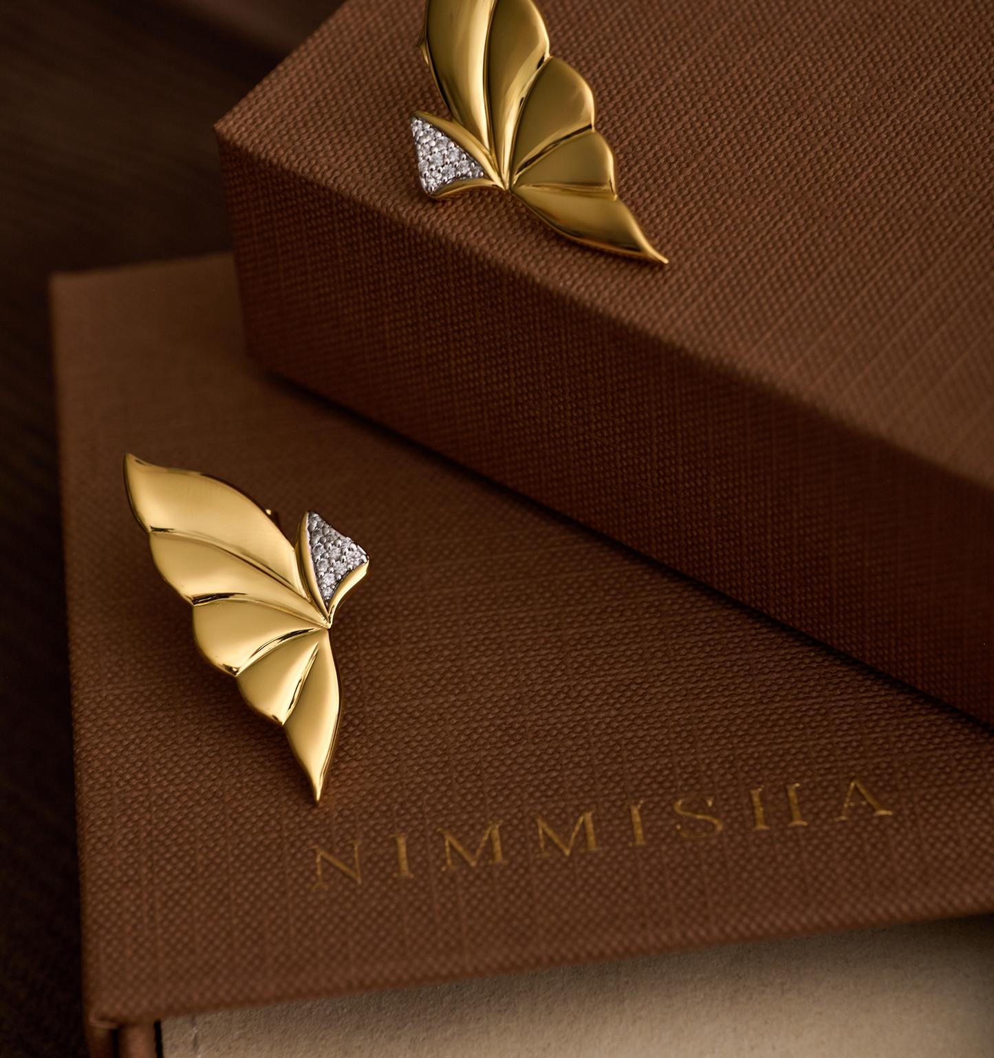Elara Earrings gold butterfly wing design with diamond accents on brown box