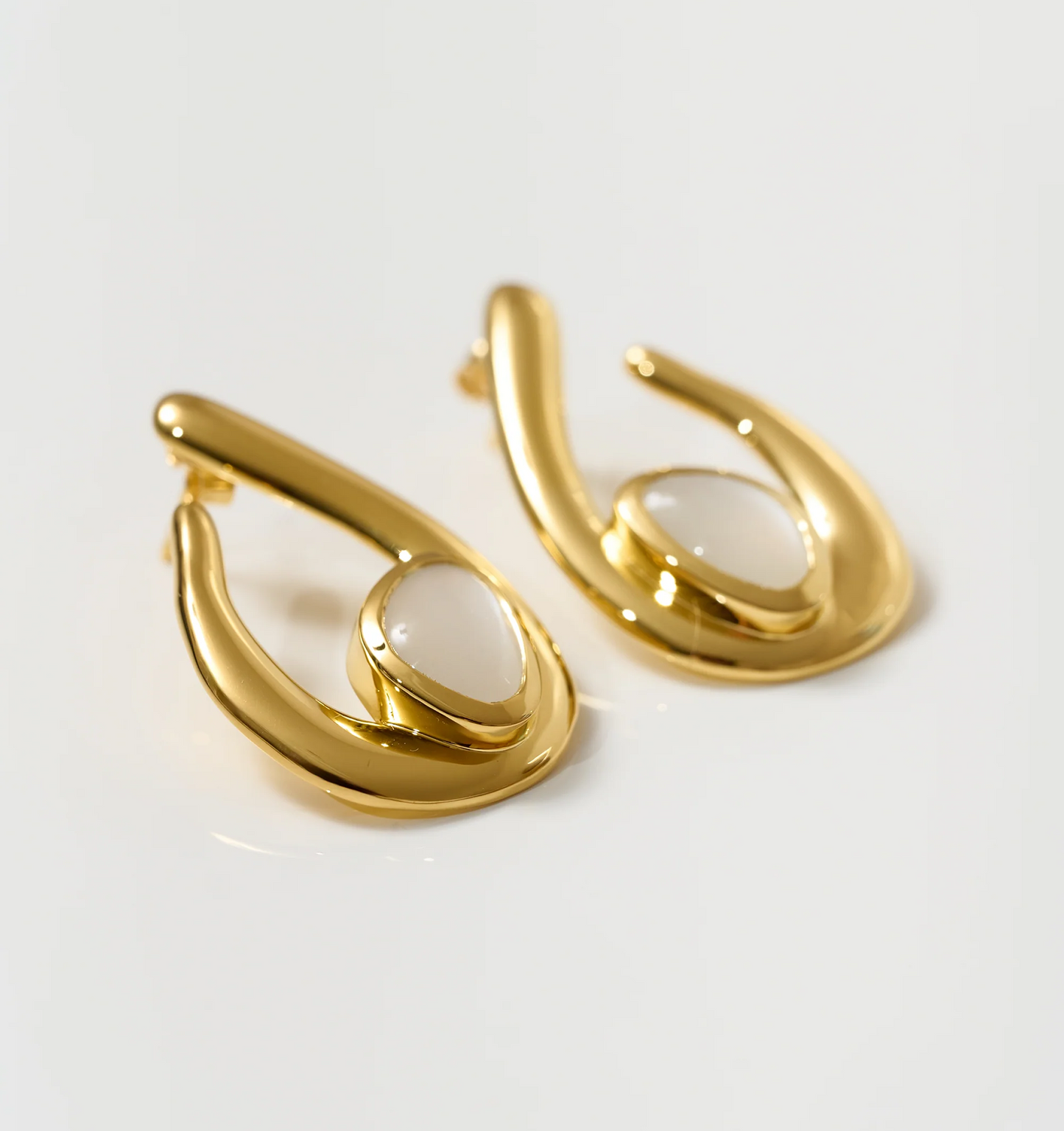 Lunara Earrings gold sculptural hoops with luminous white moonstone centerpiece