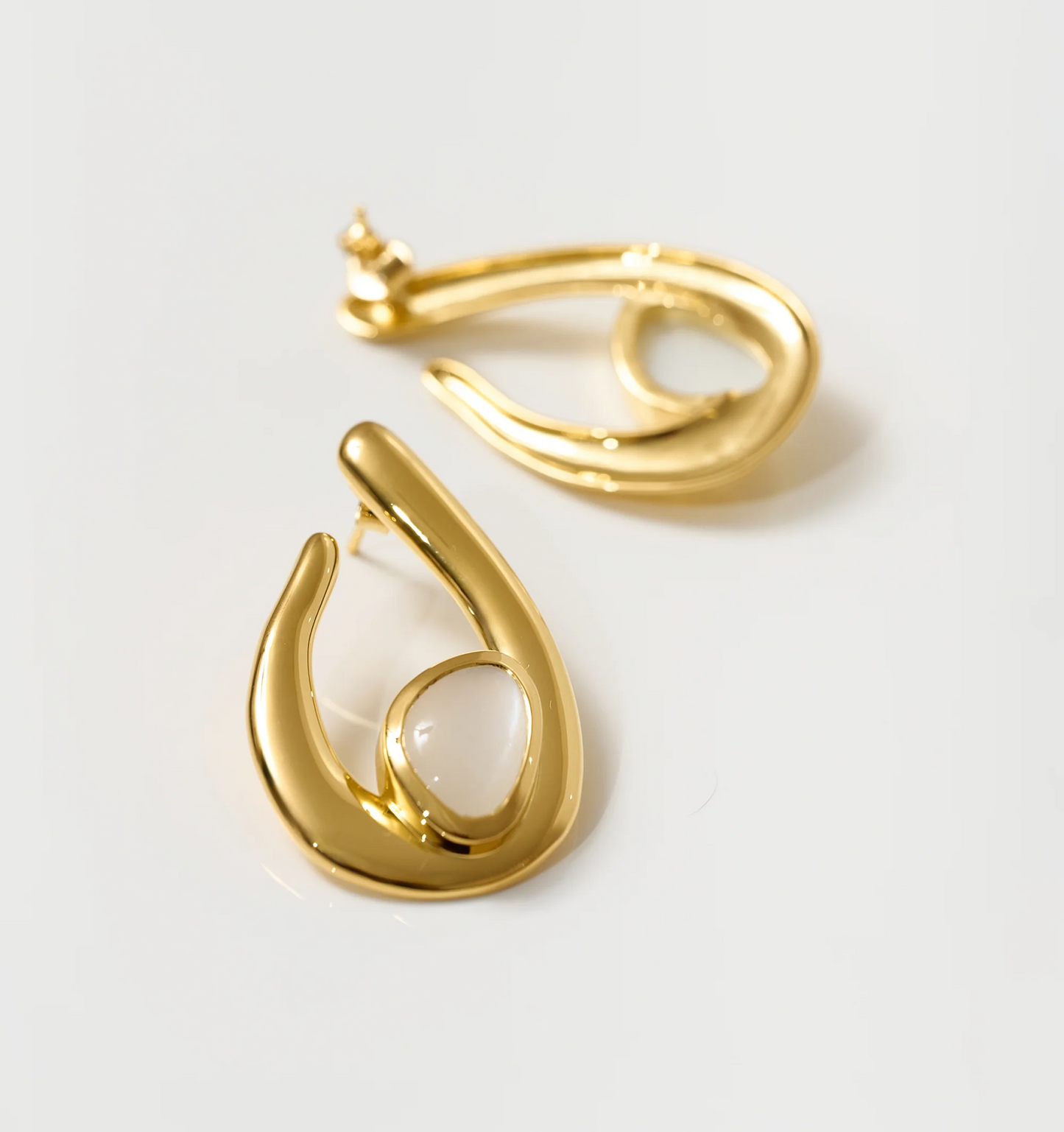 Lunara Earrings gold sculptural design with luminous white moonstone centerpiece