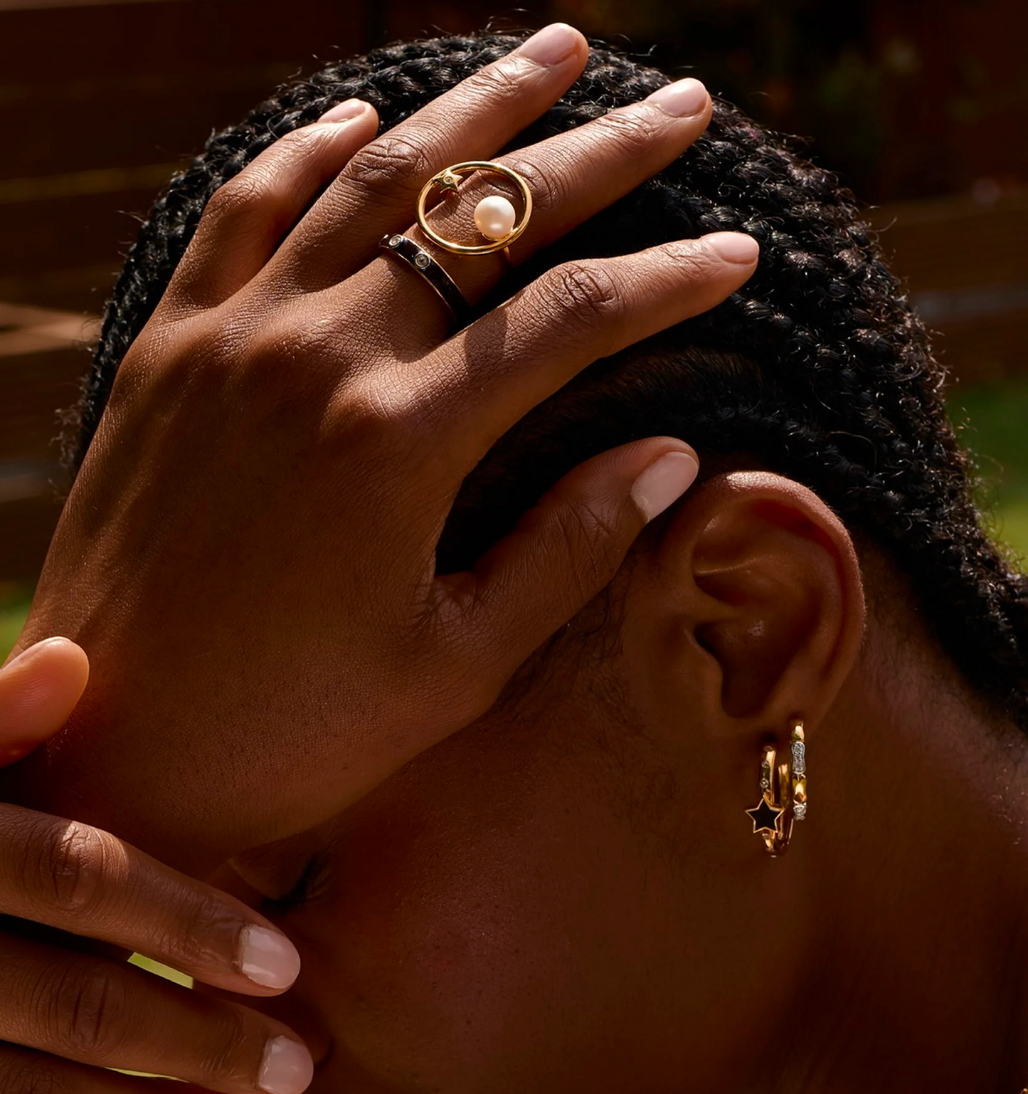 Close-up of hand wearing Trikaala Ring with white stone, symbolizing time and reflection