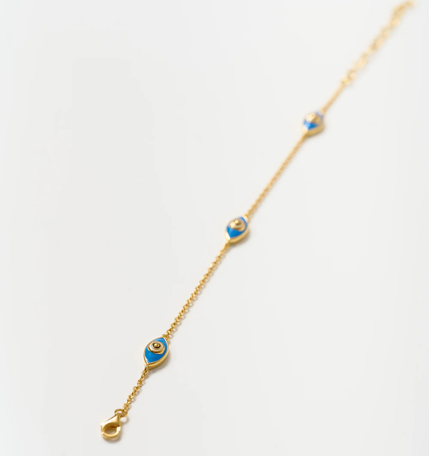 Dhrish Bracelet gold chain with turquoise enamel eye charms symbolizing clarity and protection