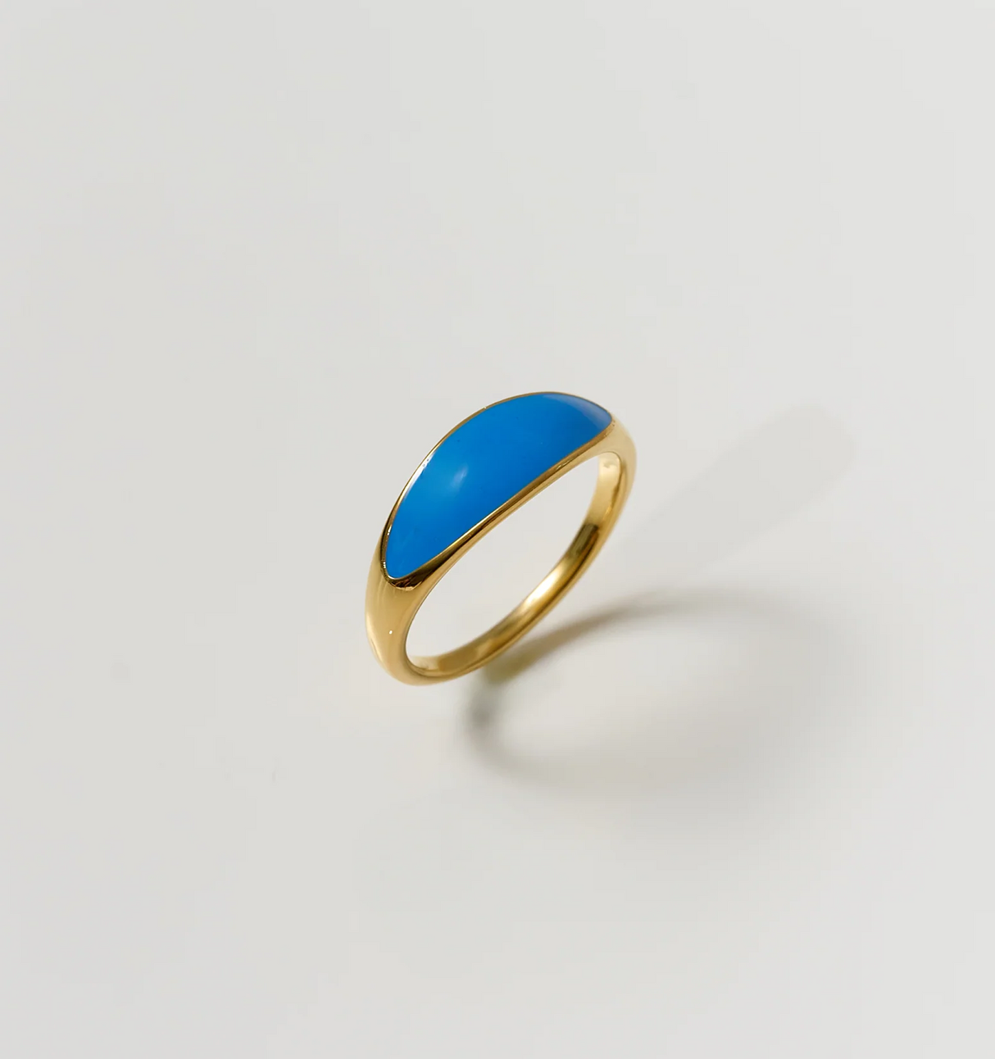 Neelra Ring gold band with smooth blue water-inspired design on plain background