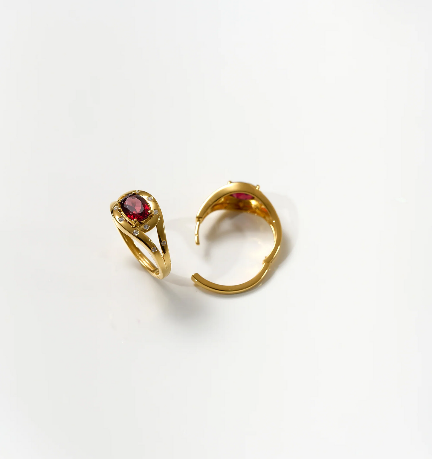 Gold Ruvya Hoops with garnet and white zircon gemstones on white background