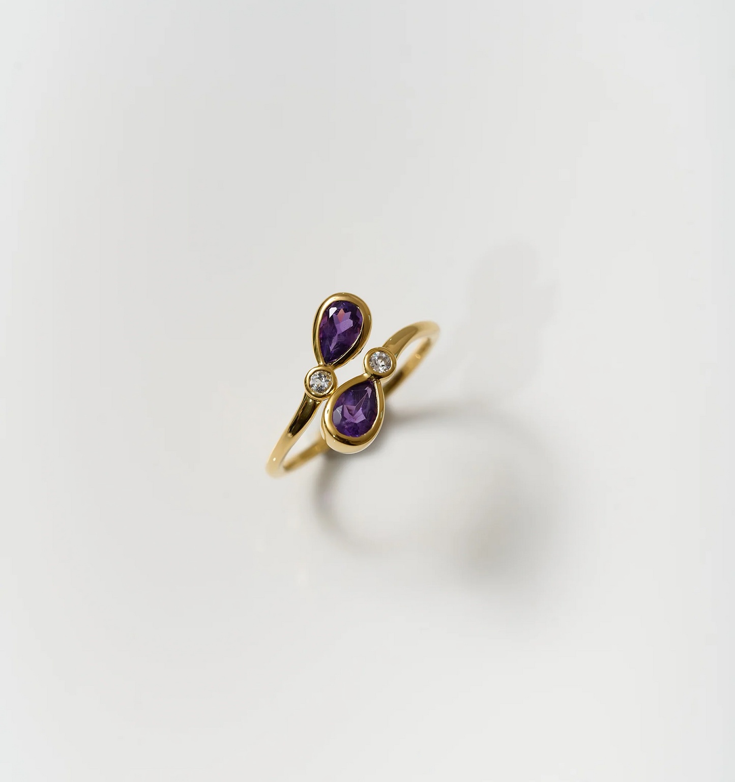 Nimira Ring with twin amethysts and white topaz set in gold band
