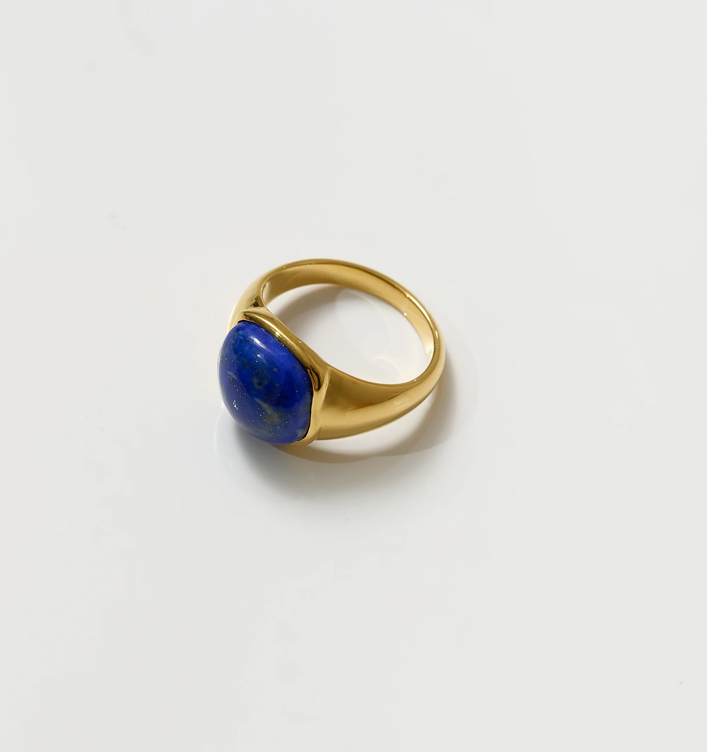 Neelaya Ring gold band with bold blue lapis stone centerpiece on white background