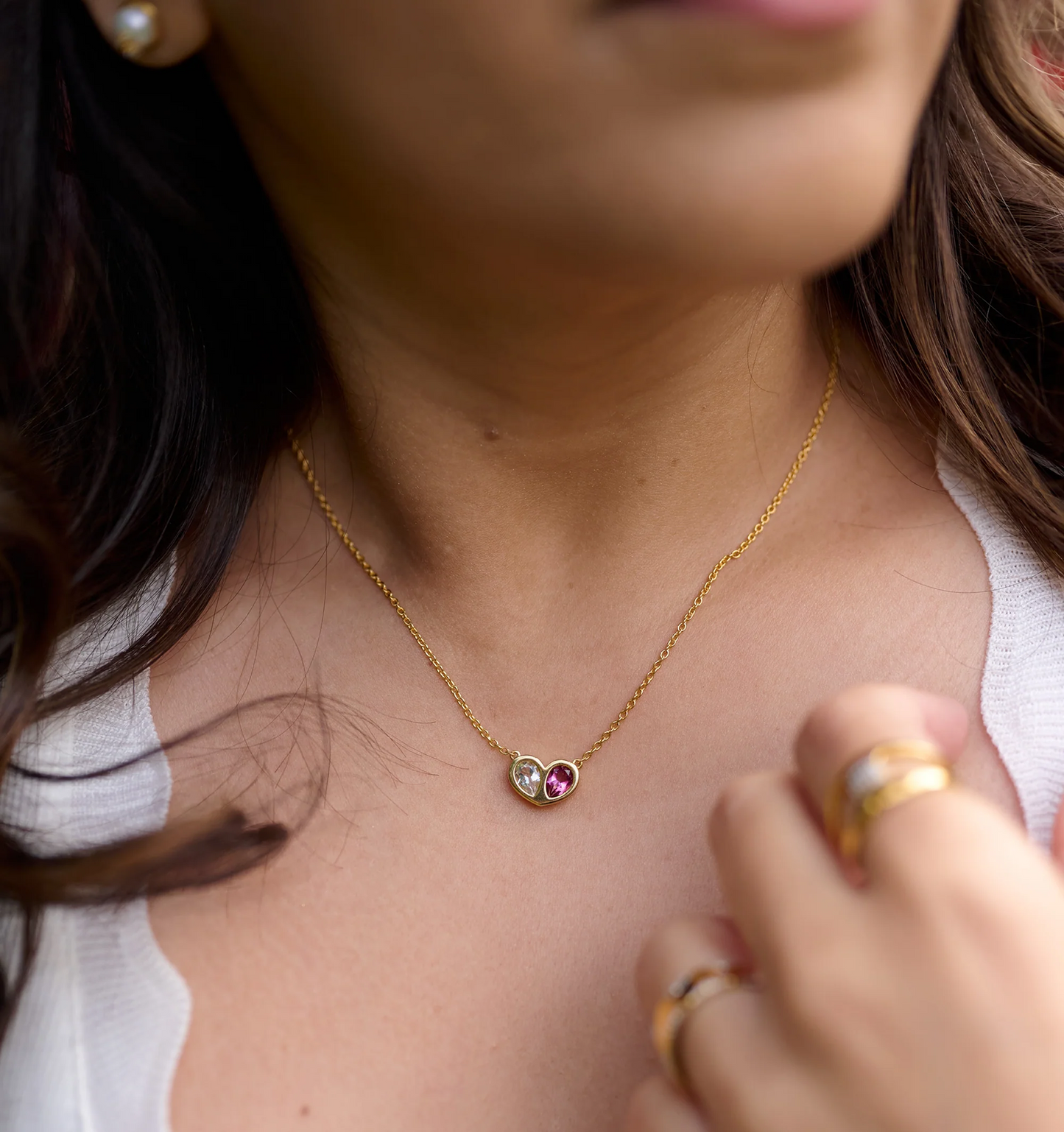 Manas Necklace with twin heart-shaped stones on gold chain symbolizing harmony and connection worn by woman