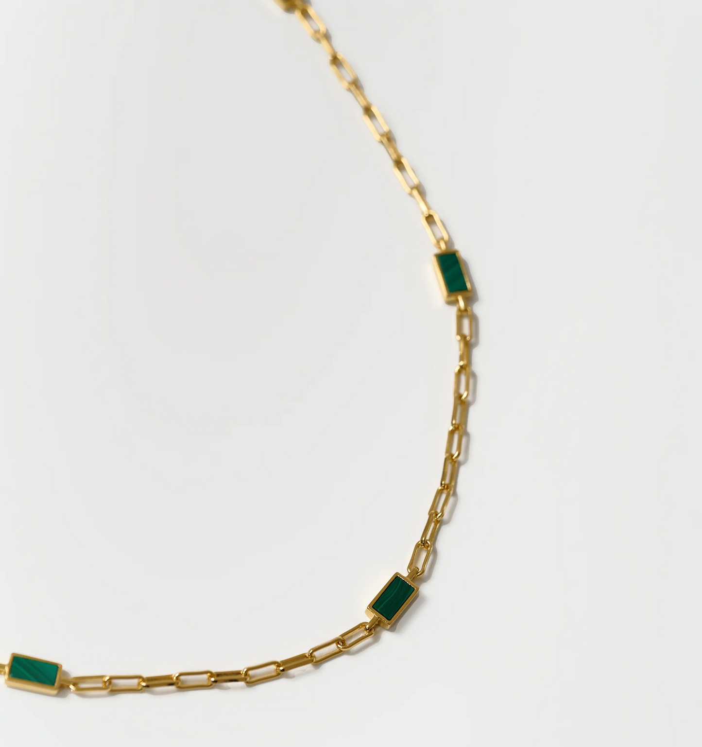 Tarang Necklace with seven green malachite stones on a gold chain balancing heart chakra energy