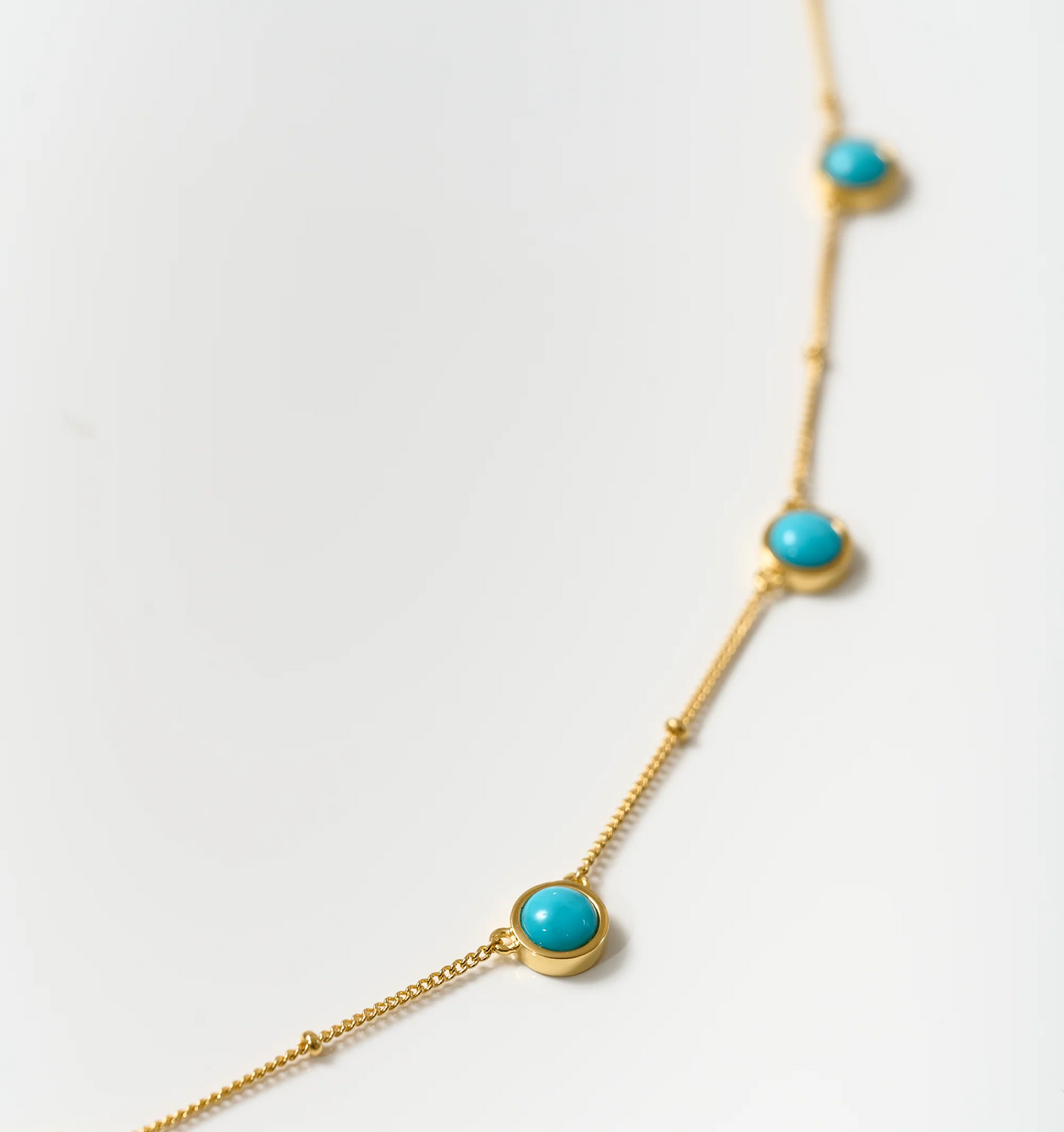 Vaani Necklace with turquoise stones set in a delicate gold chain promoting calm and honest expression