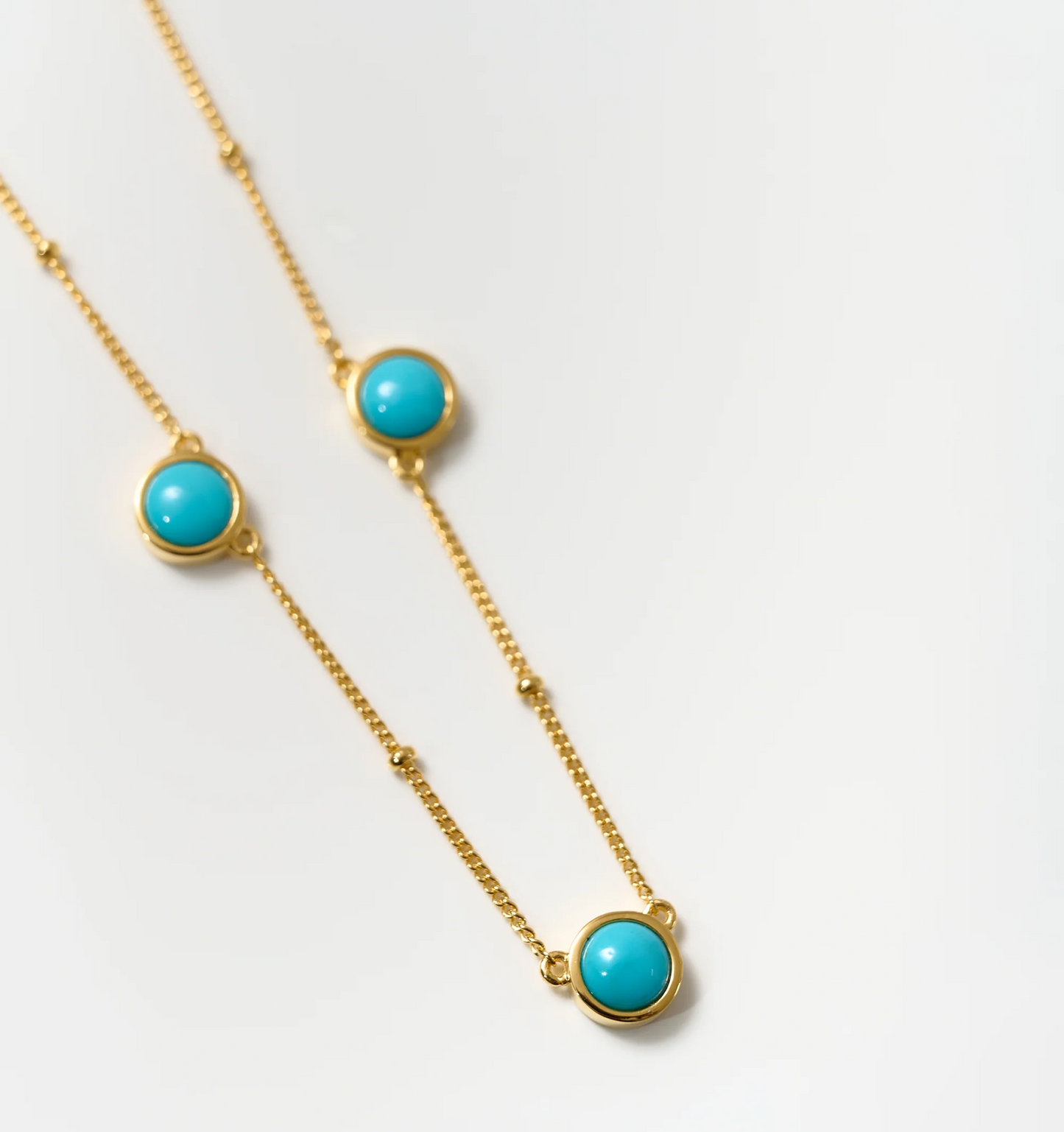 Vaani Necklace with turquoise stones on gold chain for calming and throat chakra alignment