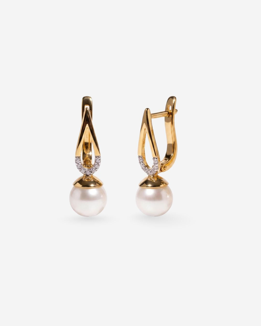Elegant Jyoti earrings featuring a pearl and gold sculptural design with white topaz accents
