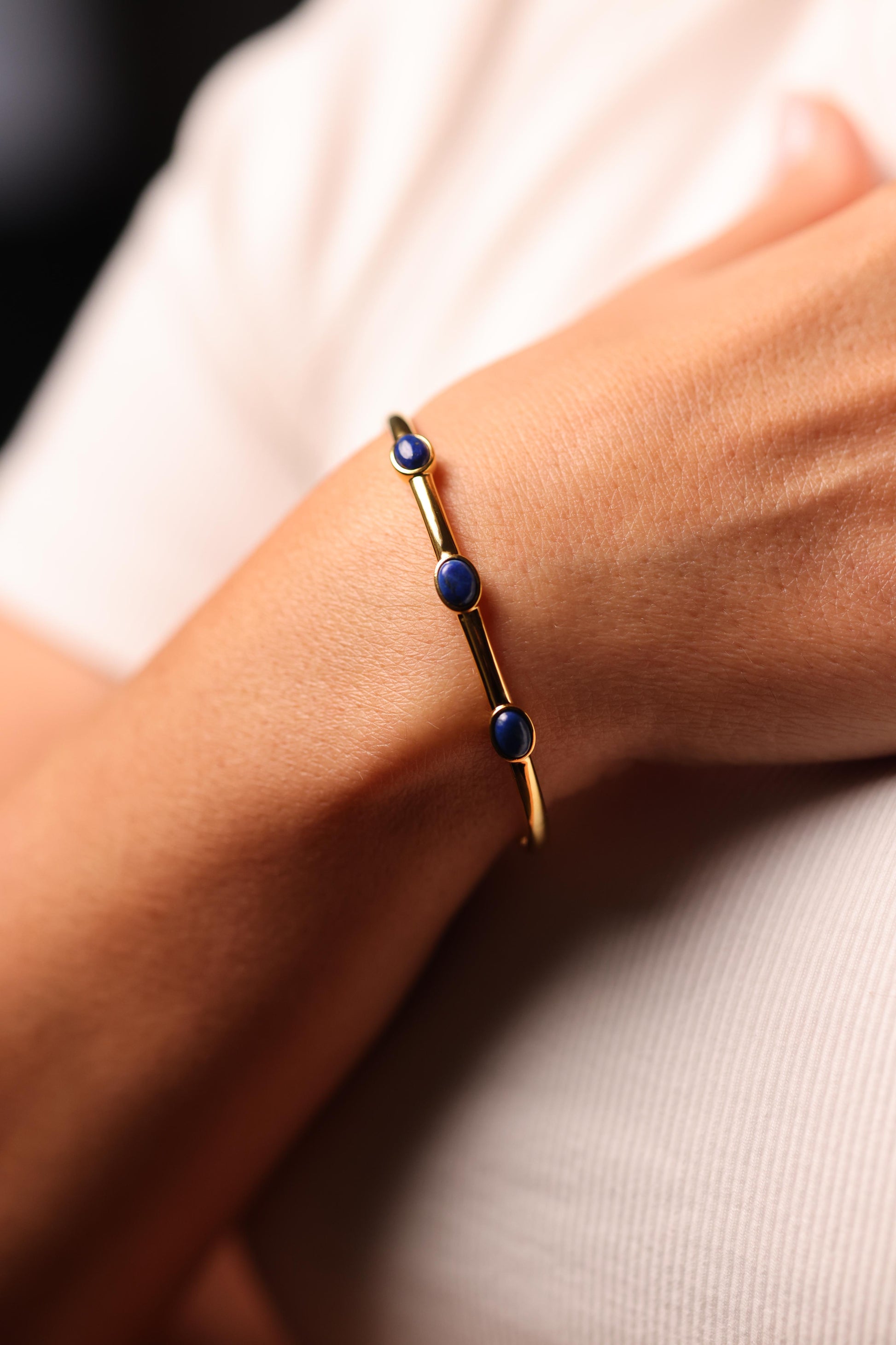 Trivena Cuff with three deep blue Lapis Lazuli cabochon stones set in a minimal gold framework