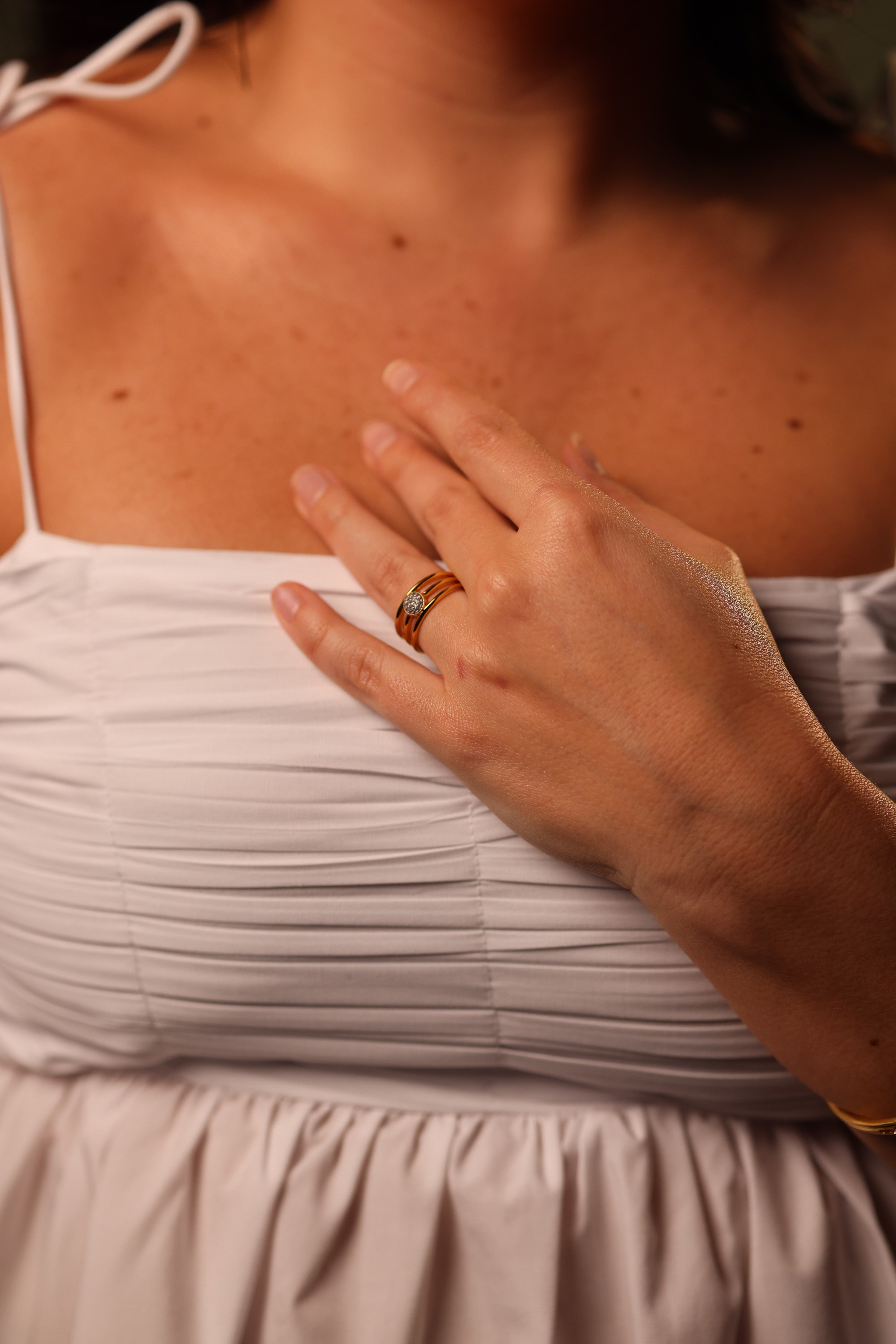 Trinetra Ring with three golden bands and radiant white topaz symbolizing inner sight and clarity