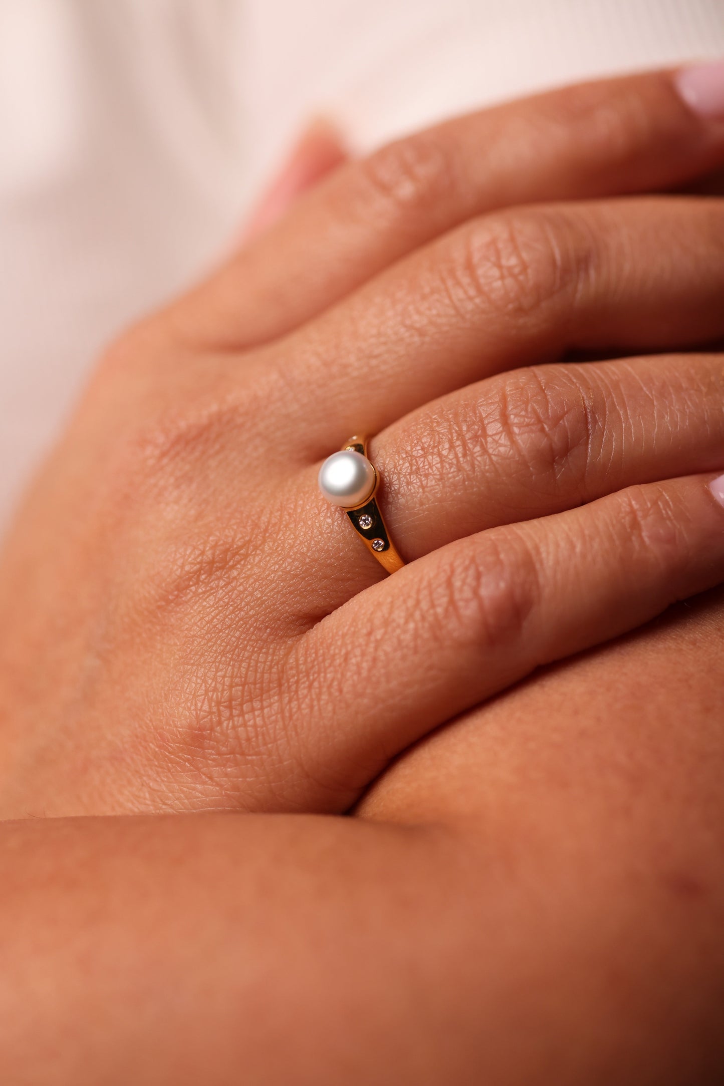 Deepa Ring with central pearl surrounded by lab-grown diamonds radiating light