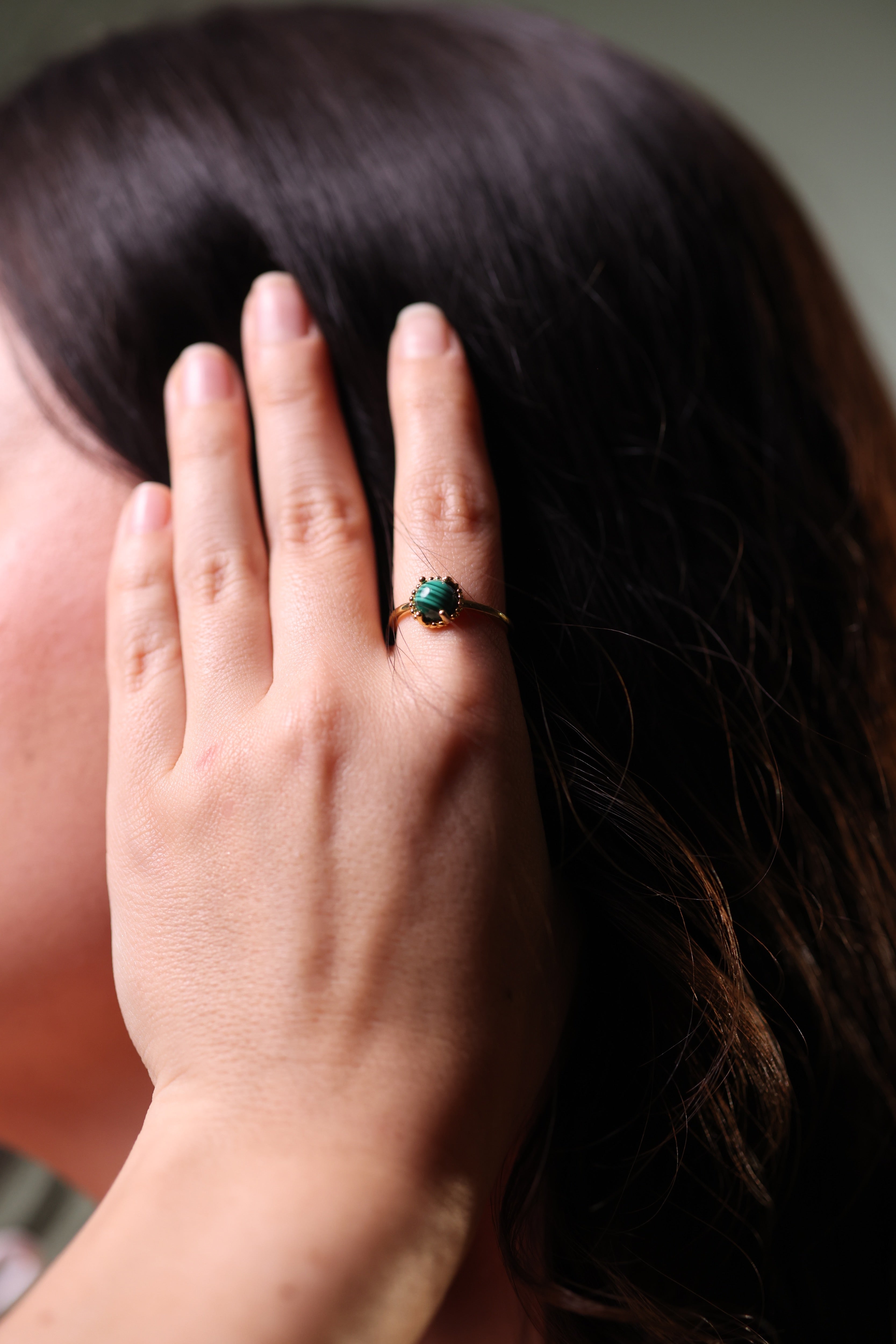 Vanya Ring with smooth round malachite stone in gold band showcasing deep green tones and modern design