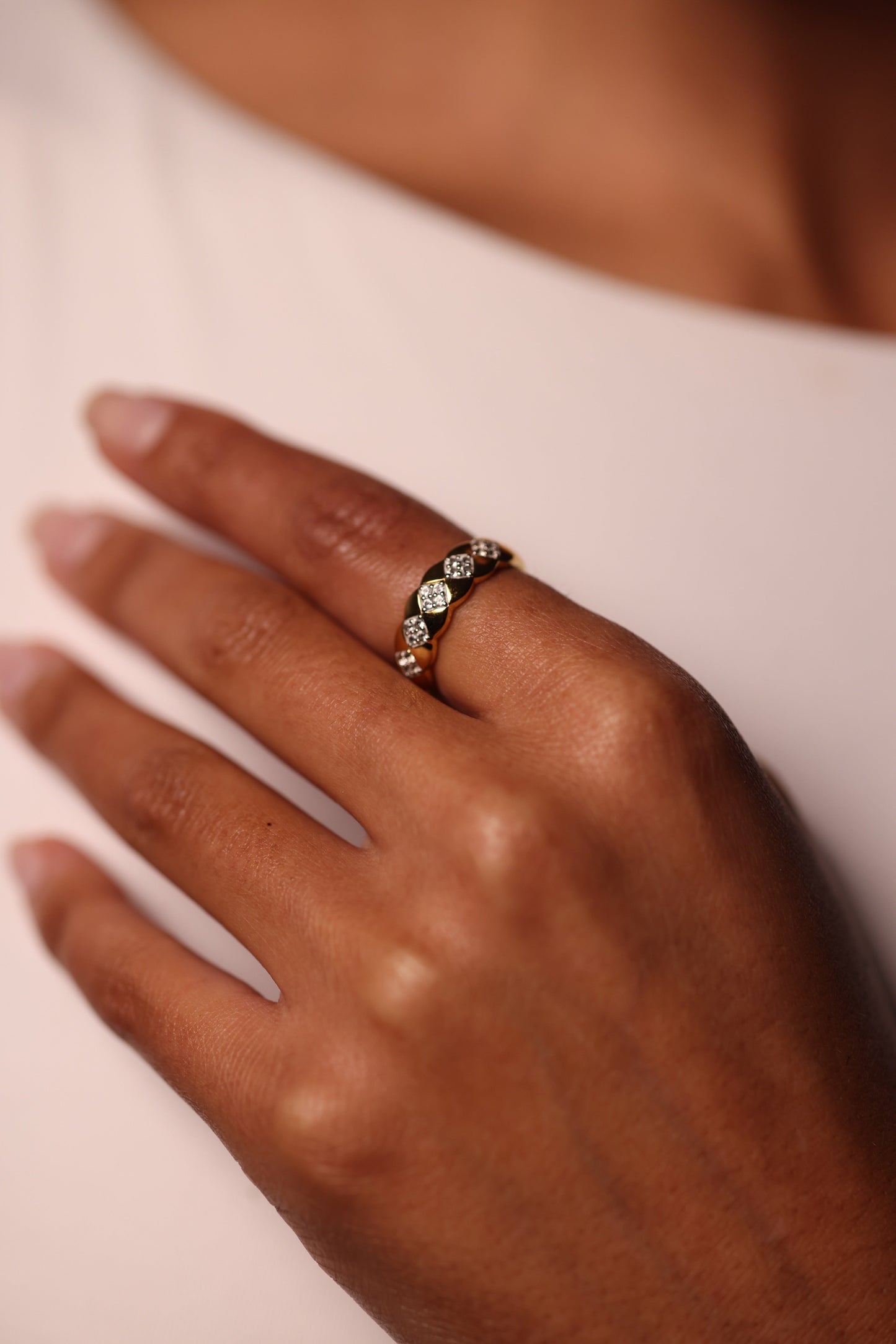 Taal Ring gold band with repeating white topaz stones in a modern, balanced design