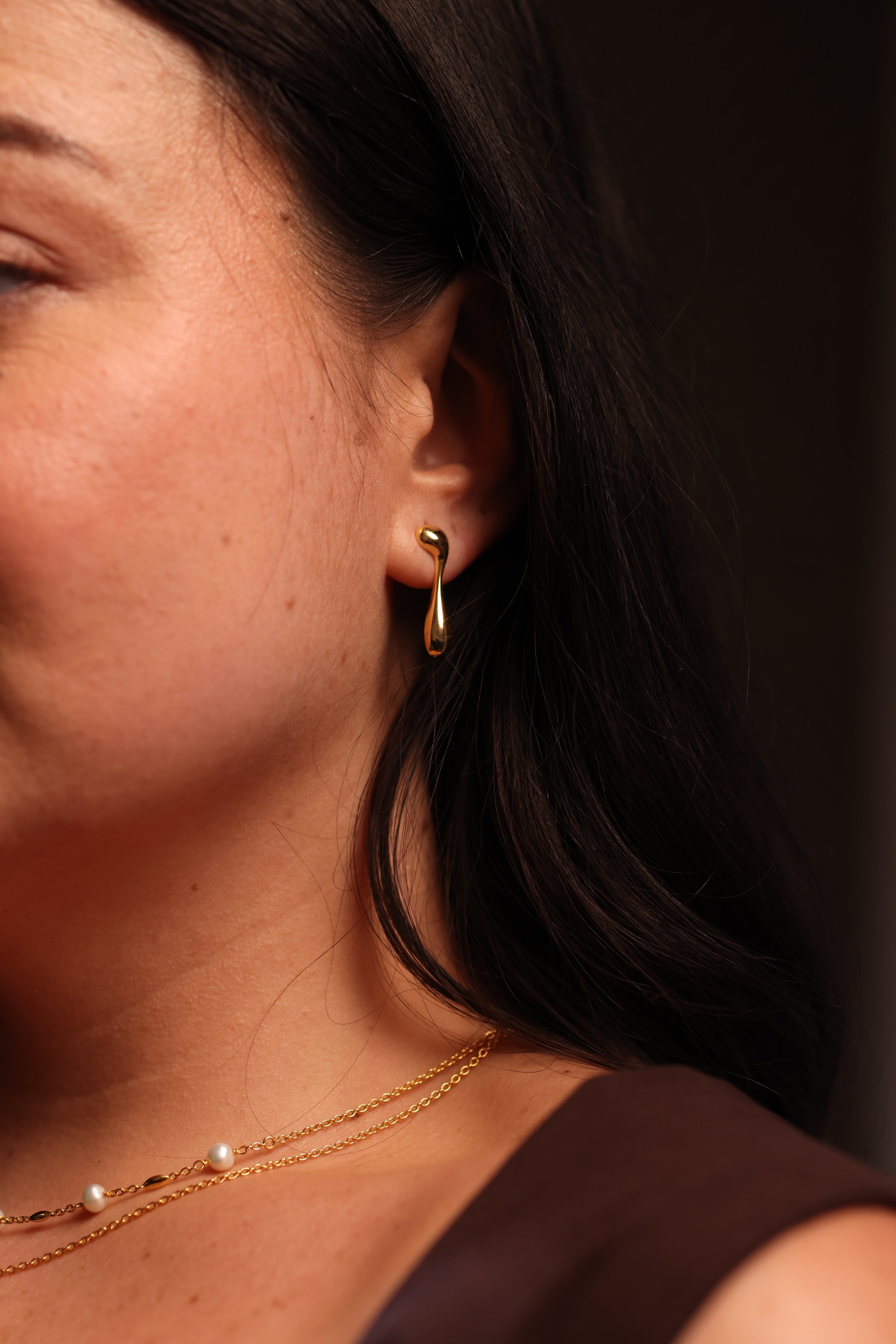 Minimal sculptural Dhara Earring with elongated fluid curve and balanced softness and strength