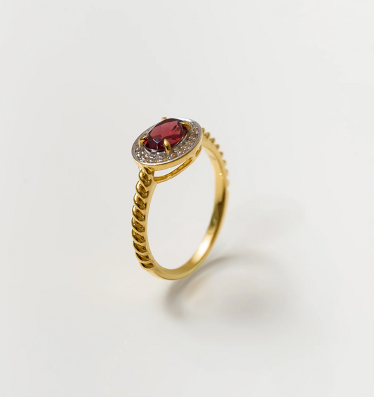 Agira Ring with garnet center stone and white topaz halo on gold band