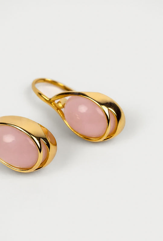 Close-up of Anvi Earrings featuring oval pink opal cabochon stones in a modern, refined setting