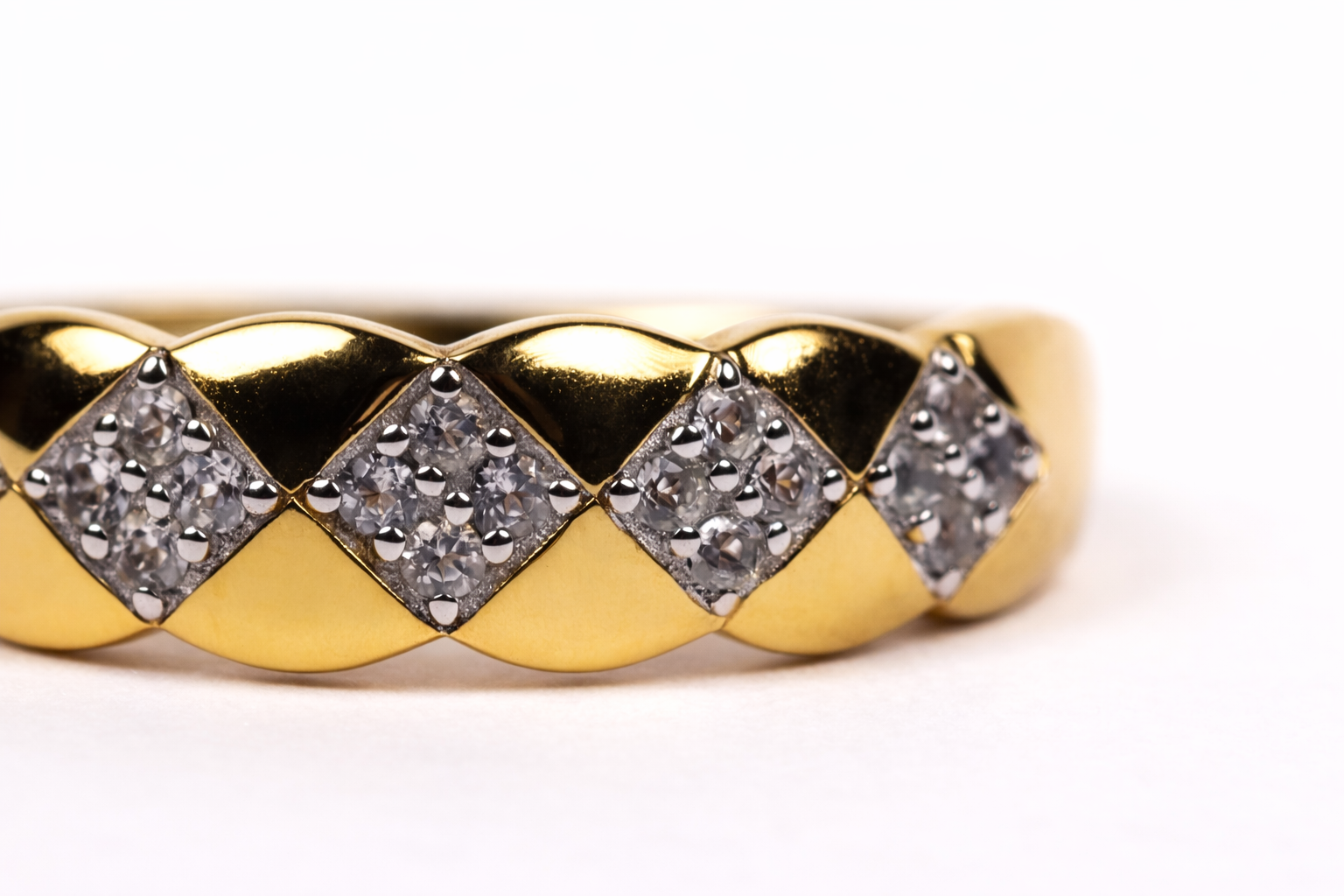 Taal Ring gold band with white topaz stones in a repeating pattern