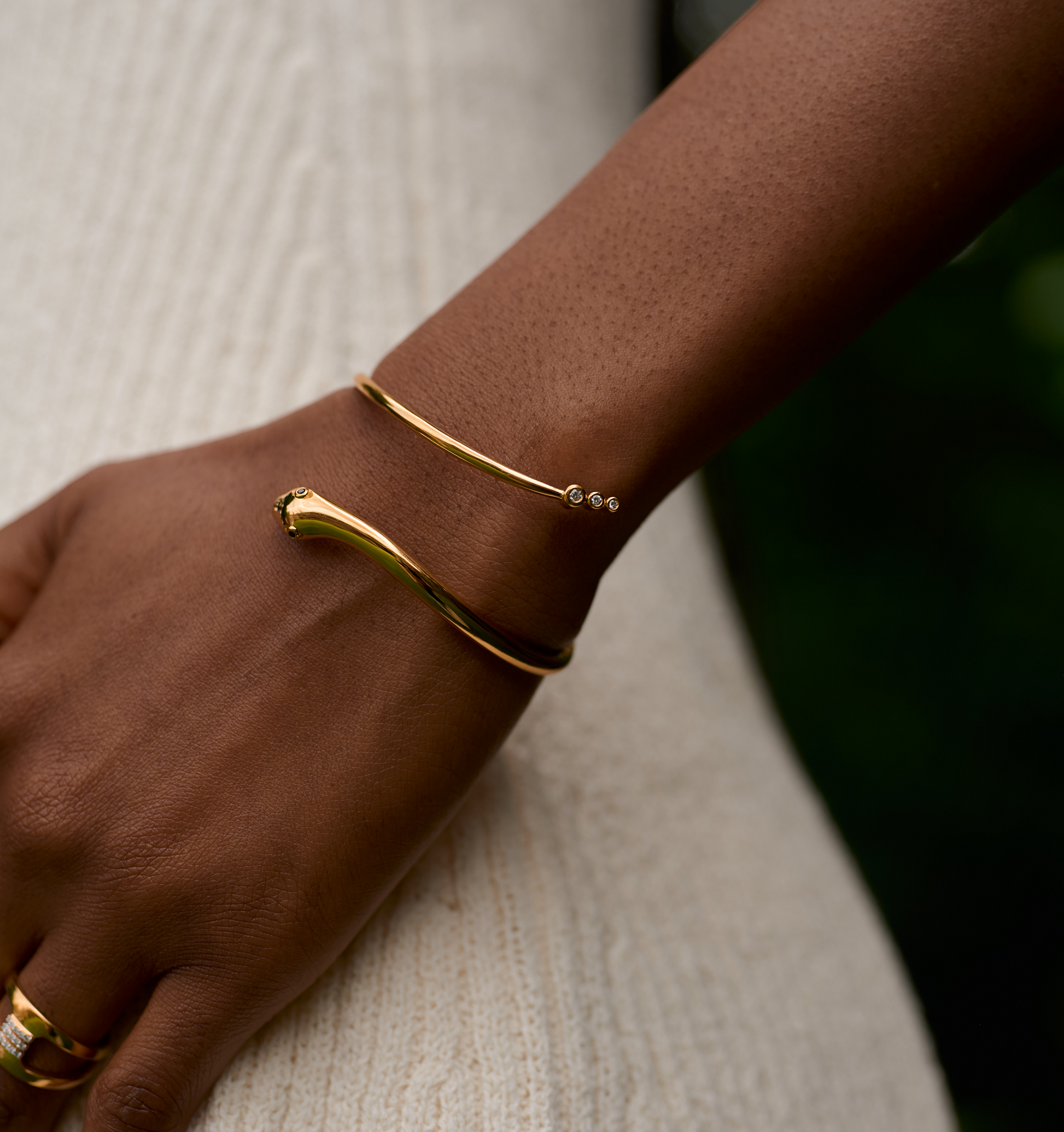 Gold Sarpa Cuff serpent bracelet with black spinel eyes and diamond details on wrist