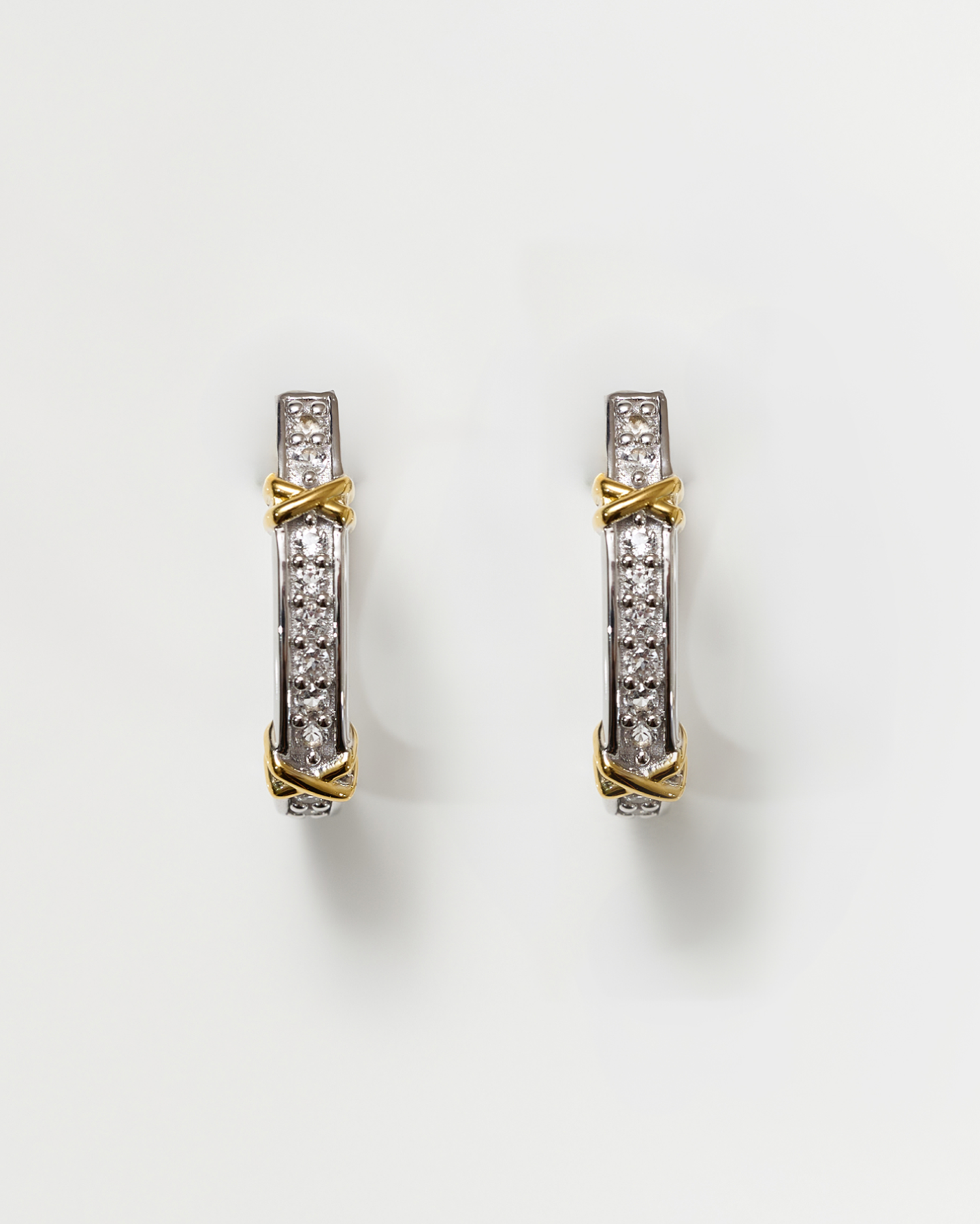 Aarvi Hoops gold and silver earrings with pavé white topaz gemstones in a sleek curved design