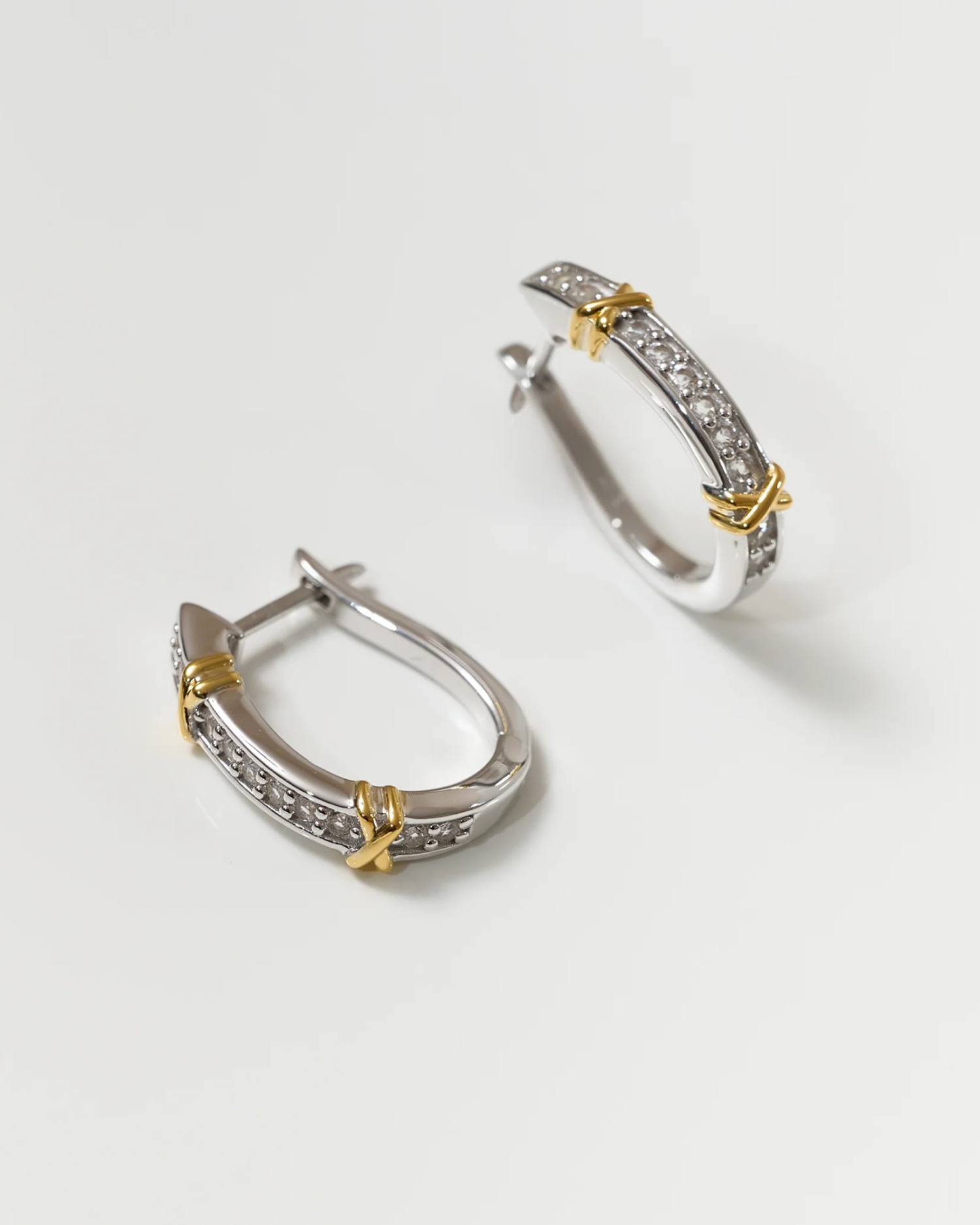 Aarvi Hoops gold and silver earrings with pavé white topaz stones and unique curve design