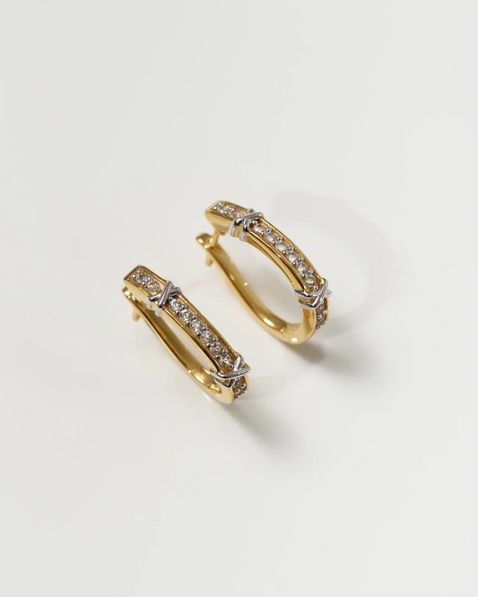 Gold Aarvi Hoops earrings with pavé white topaz stones on a neutral background