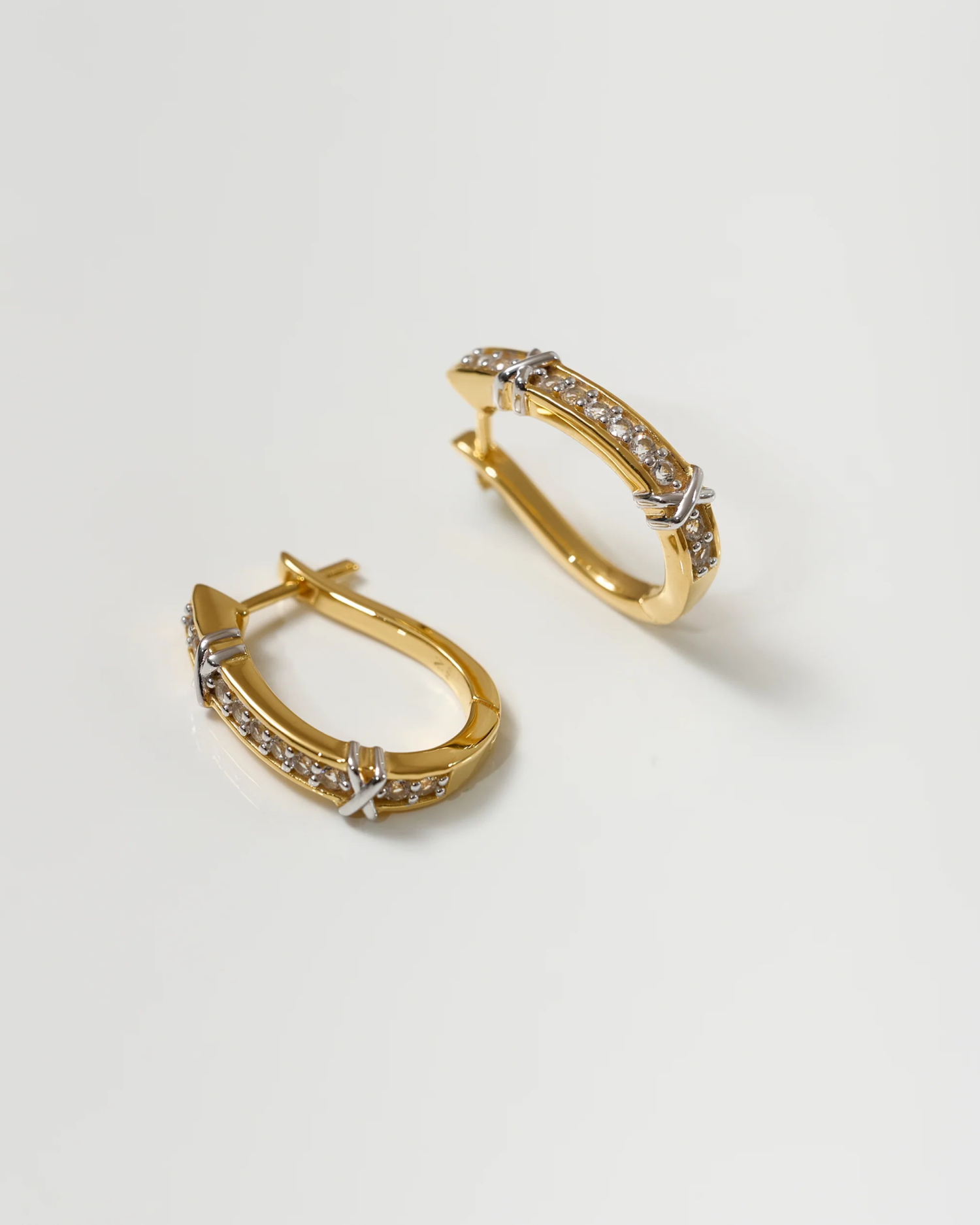 Aarvi Hoops gold earrings with pavé white topaz stones on a white background