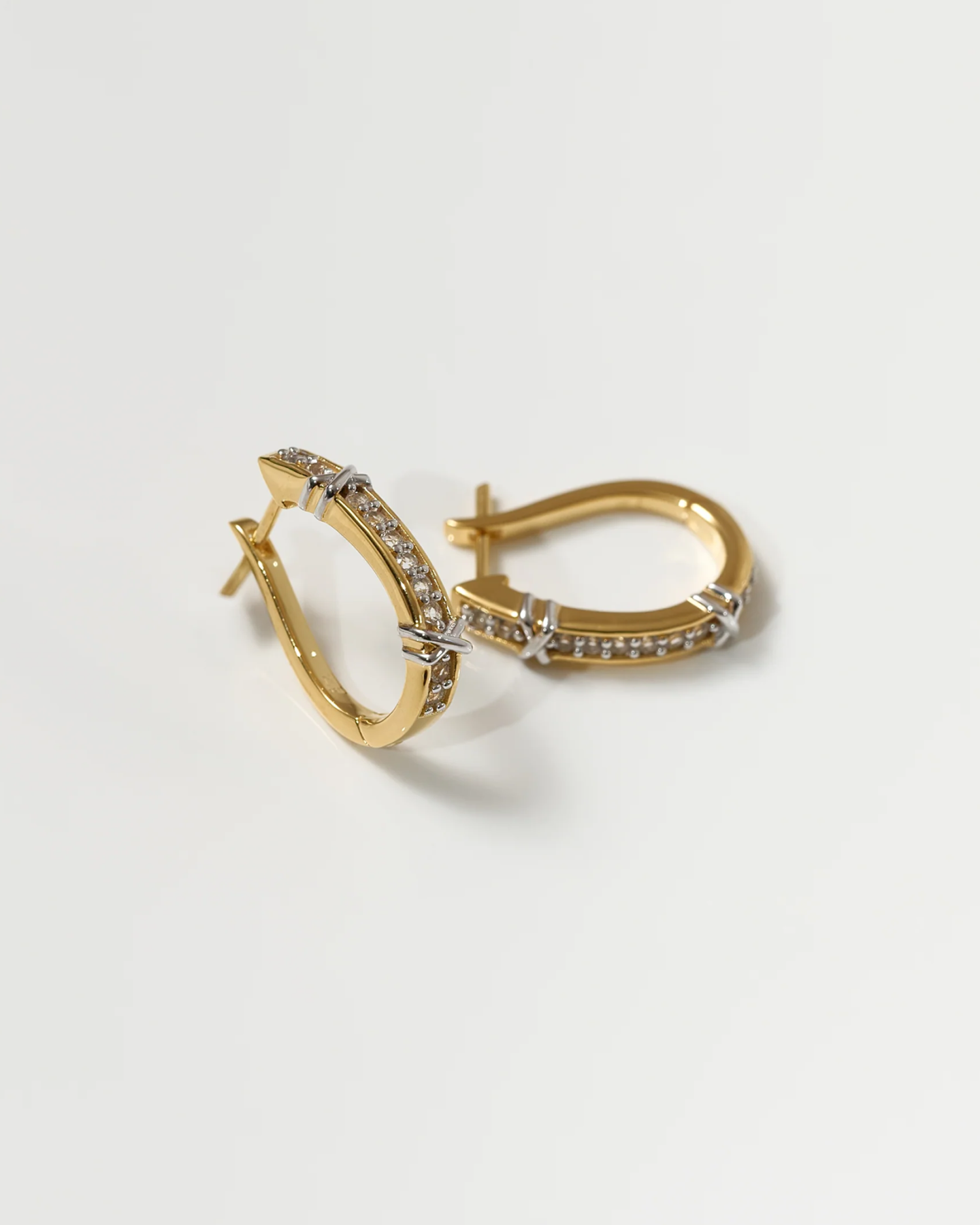 Aarvi Hoops gold earrings with pavé white topaz stones in a curved design