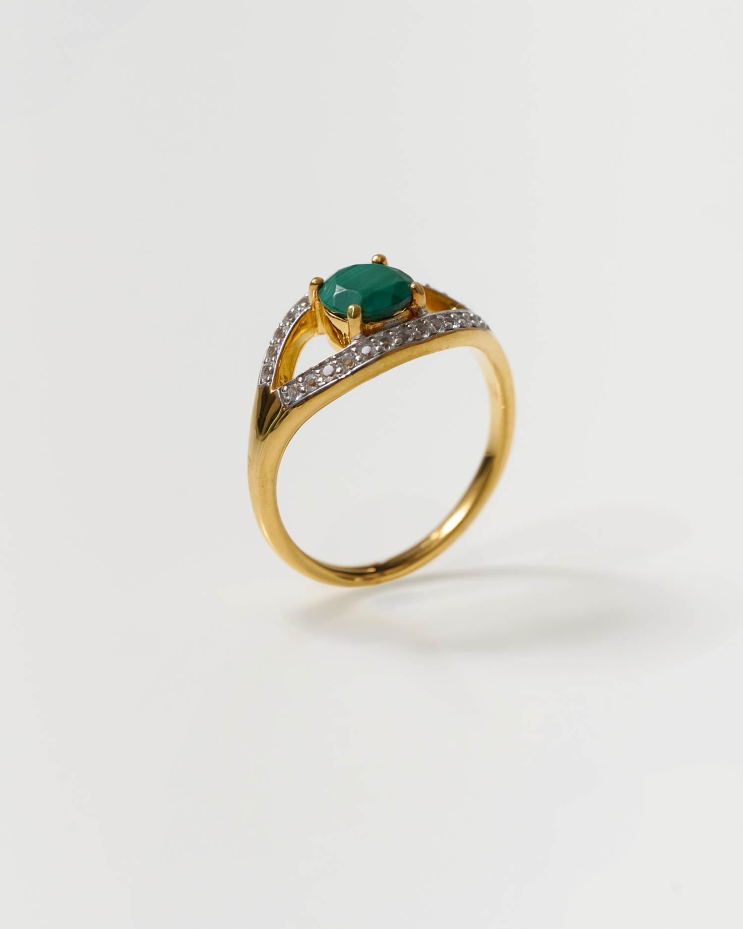 Saena Ring gold band with green stone and diamond accents isolated on white background