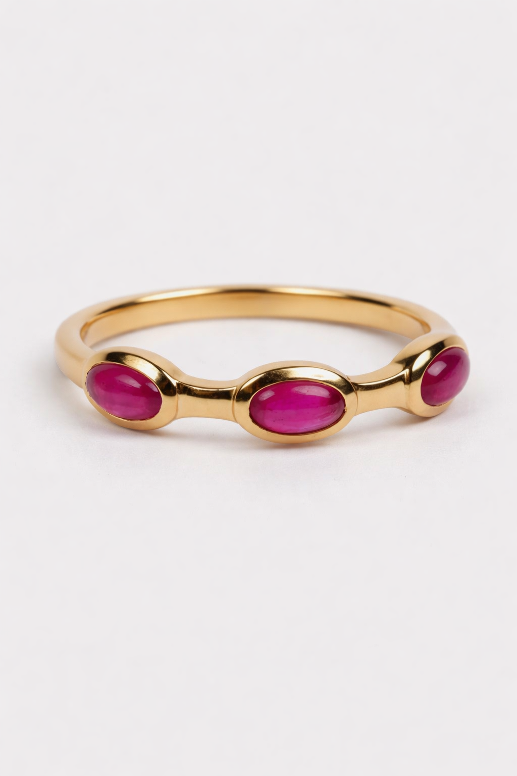 Manikya Ring with fissure filled ruby stones set in a refined gold band showcasing vibrant red hues and modern design