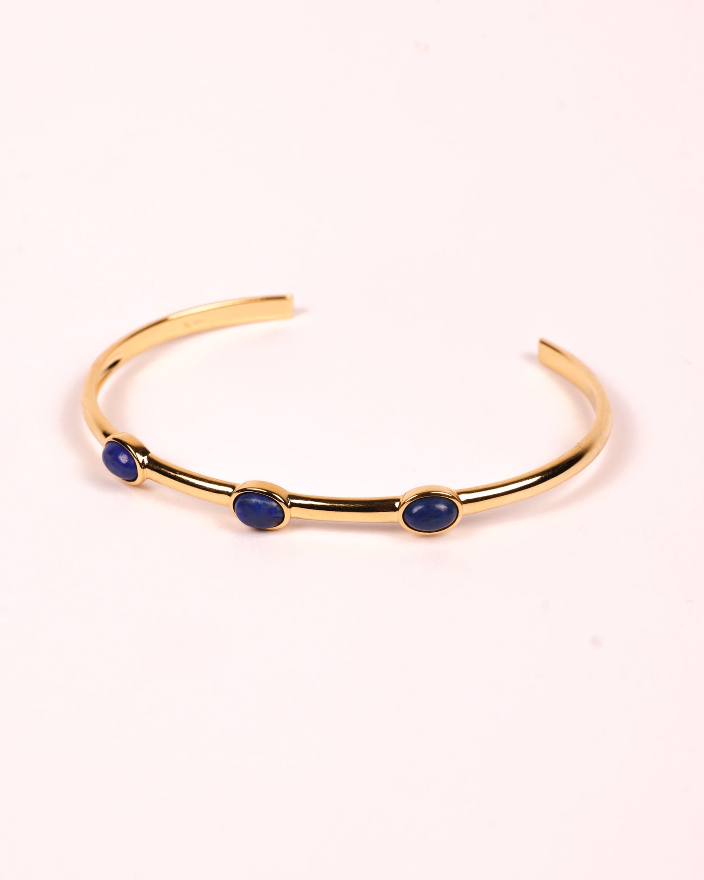 Trivena Cuff with three deep blue Lapis Lazuli stones set in a minimal gold framework for grounded elegance