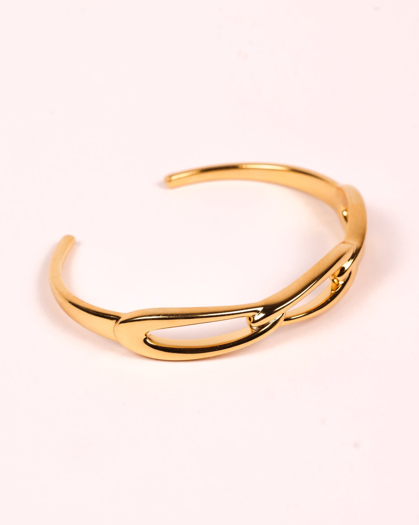 Kadi Cuff gold sculptural cuff with interlinked forms and modern open design