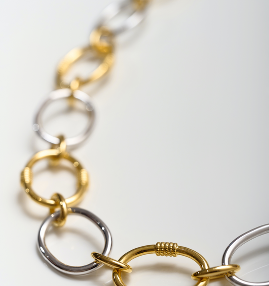 Tasya Necklace featuring interlinked gold and silver rings in a modern, balanced design