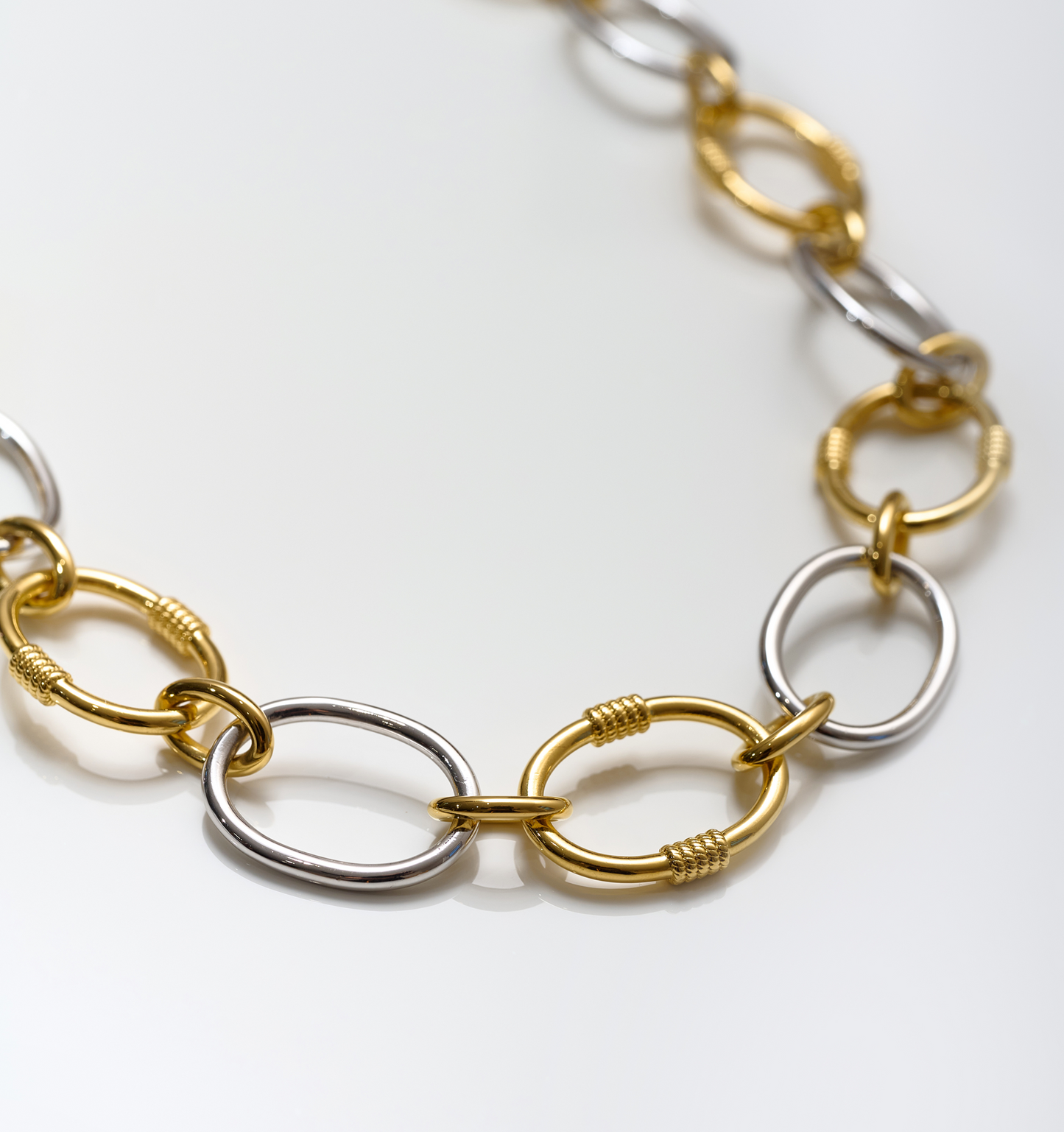 Tasya Necklace featuring interlinked gold and silver oval rings in a modern, balanced design