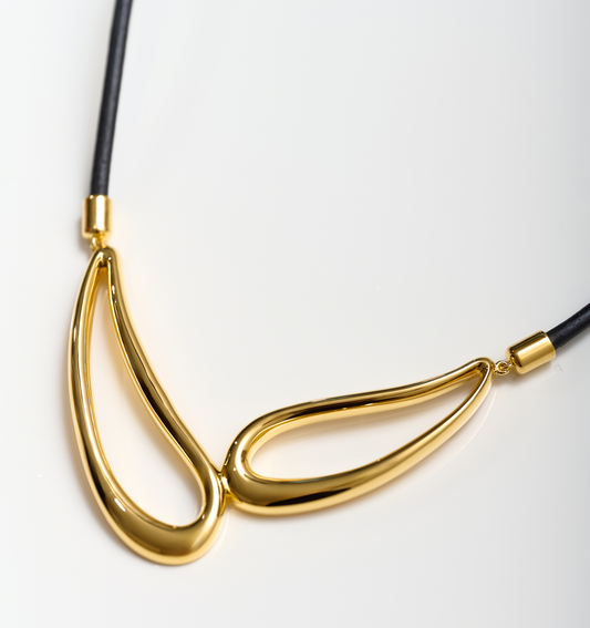 Saha Necklace gold sculpted twin forms pendant on black cord