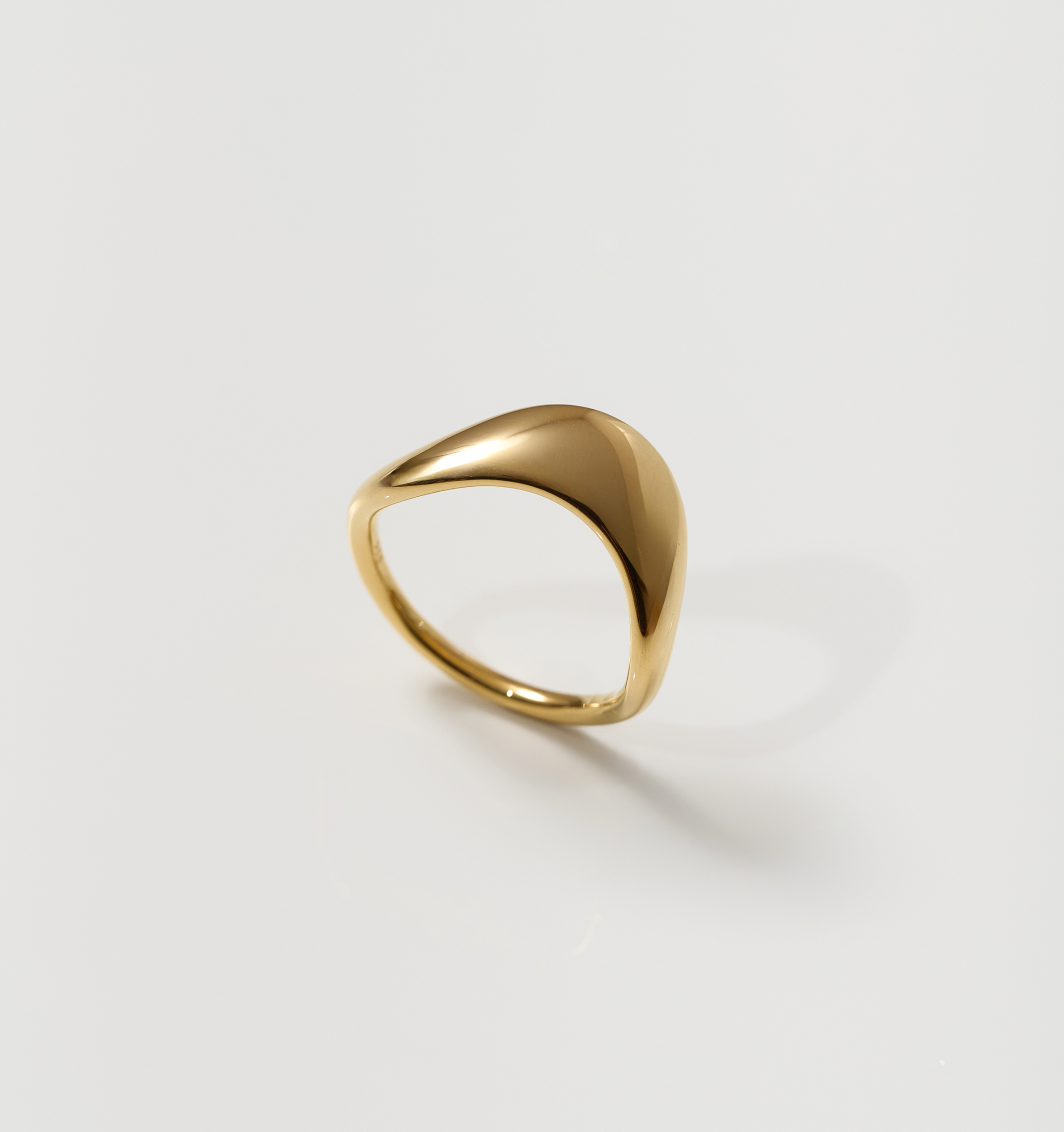 Minimalist smooth gold Alav Ring symbolizing calm and harmony in motion
