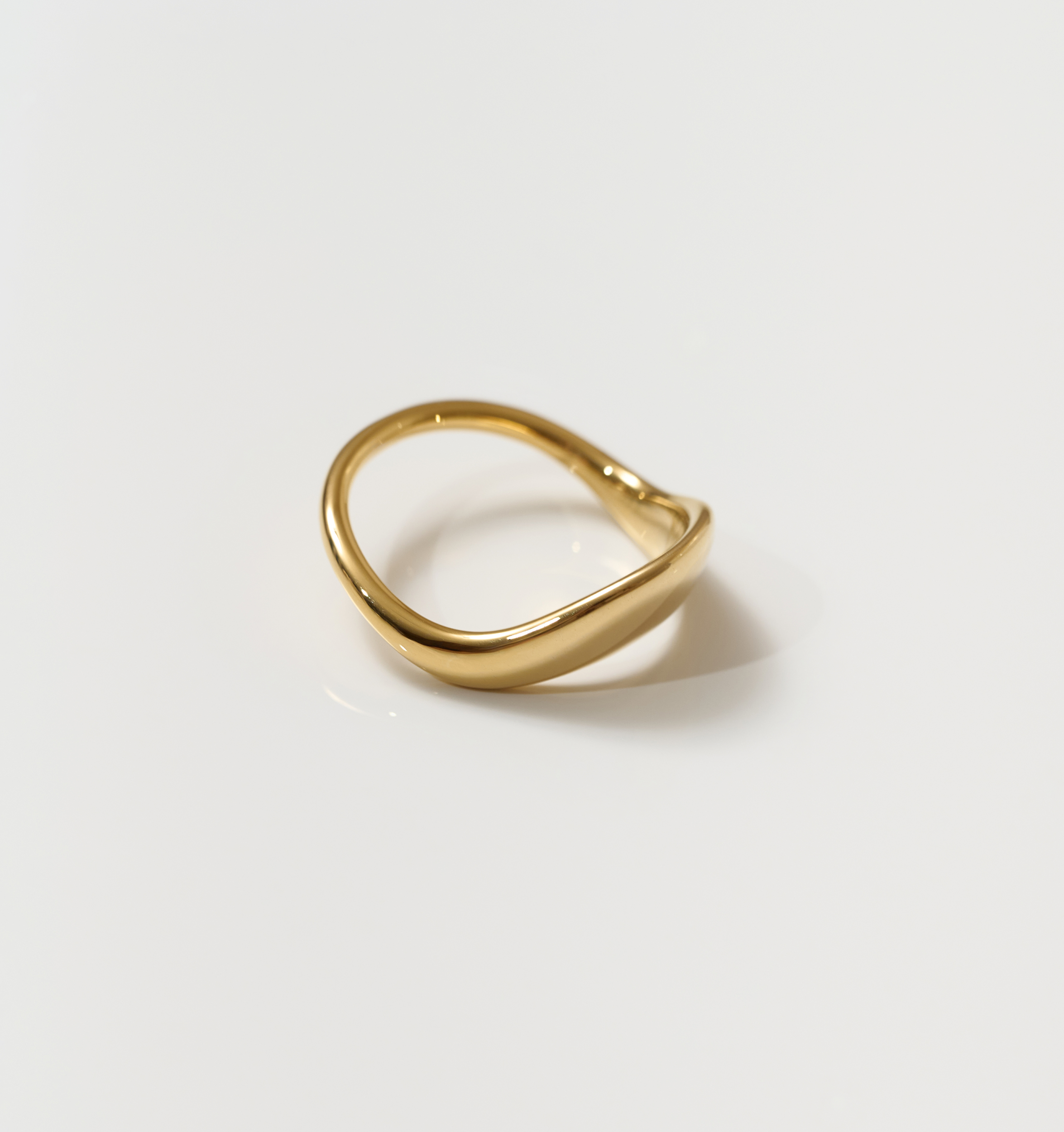 Alav Ring gold minimalist design with smooth curved shape on white background
