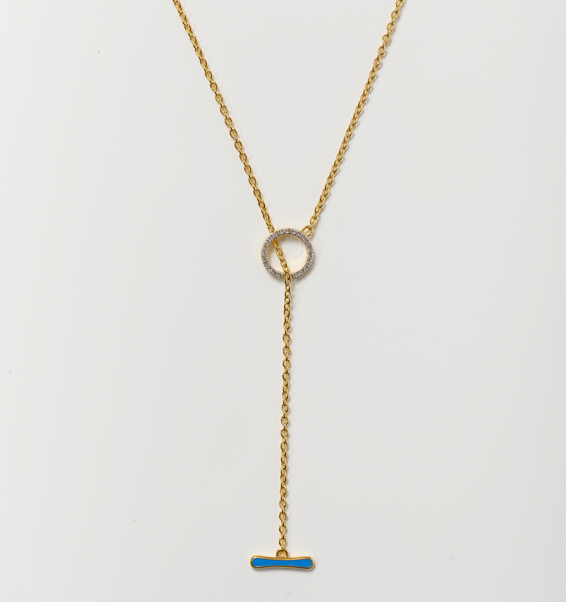 Orya Necklace gold chain with white topaz circle and blue bar pendant