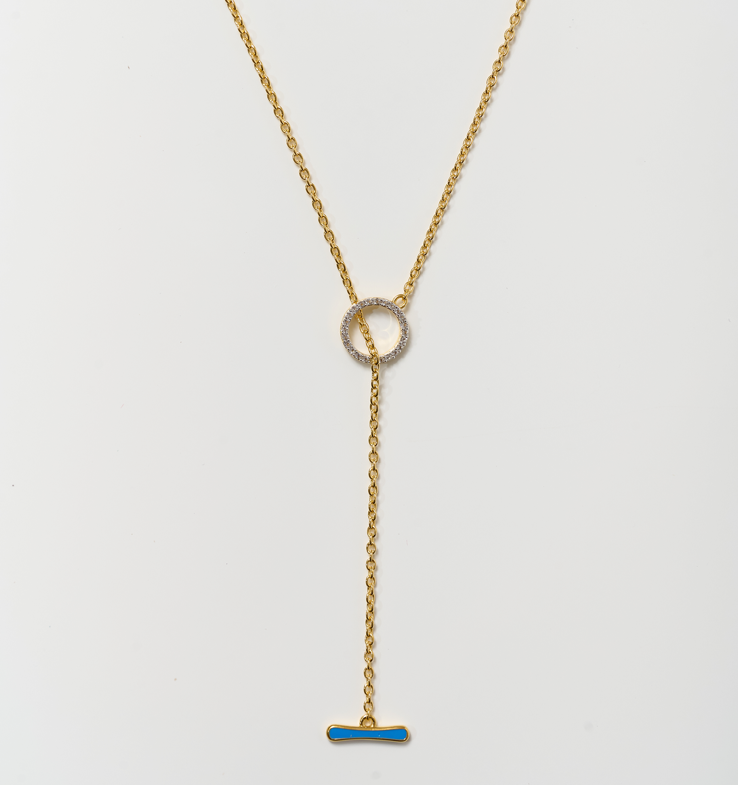 Orya Necklace gold chain with white topaz circle and blue bar pendant