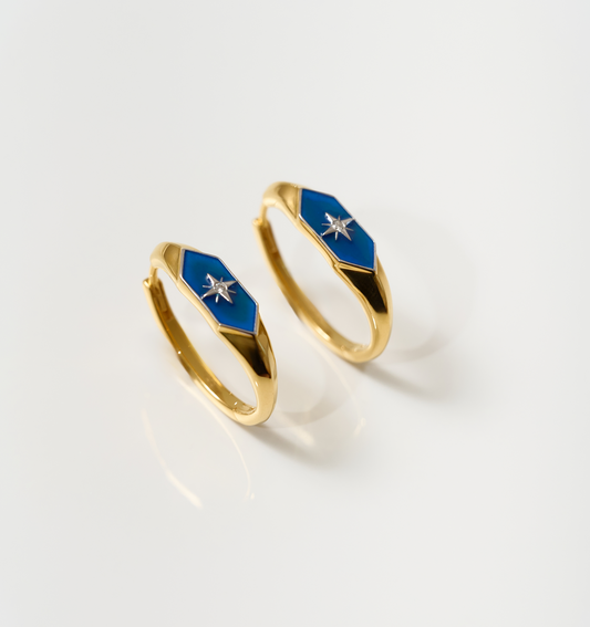 Gold Lumira Hoops with blue enamel and star detail on white background