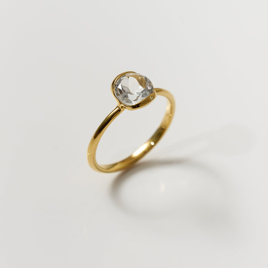 Ruhi Ring with delicately angled white topaz set in polished gold band reflecting clarity and elegance